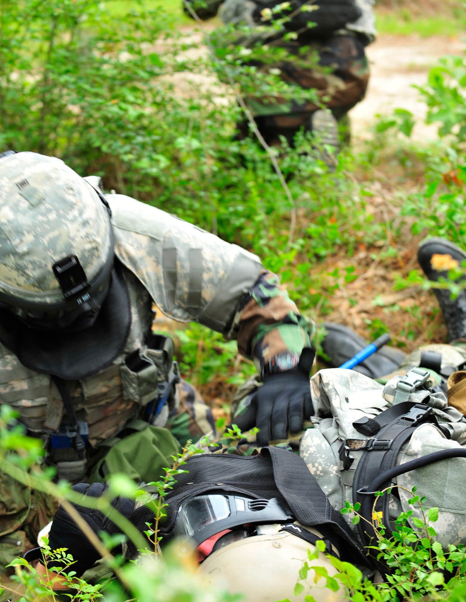 MOODY AIR FORCE BASE, Ga - - Master Sgt. Joseph Edwards, 820th Security Forces Group vehicle maintenance manager, treats Tech. Sgt. Jason Pearl, 820th Security Forces Group engineering craftsmen, for an open chest wound here May 22. During the Combat Medical Skills training exercise, these Airmen simulate many different scenarios that help prepare for the stresses they may encounter while deployed. (U.S. Air Force photo by Senior Airman Schelli Jones)