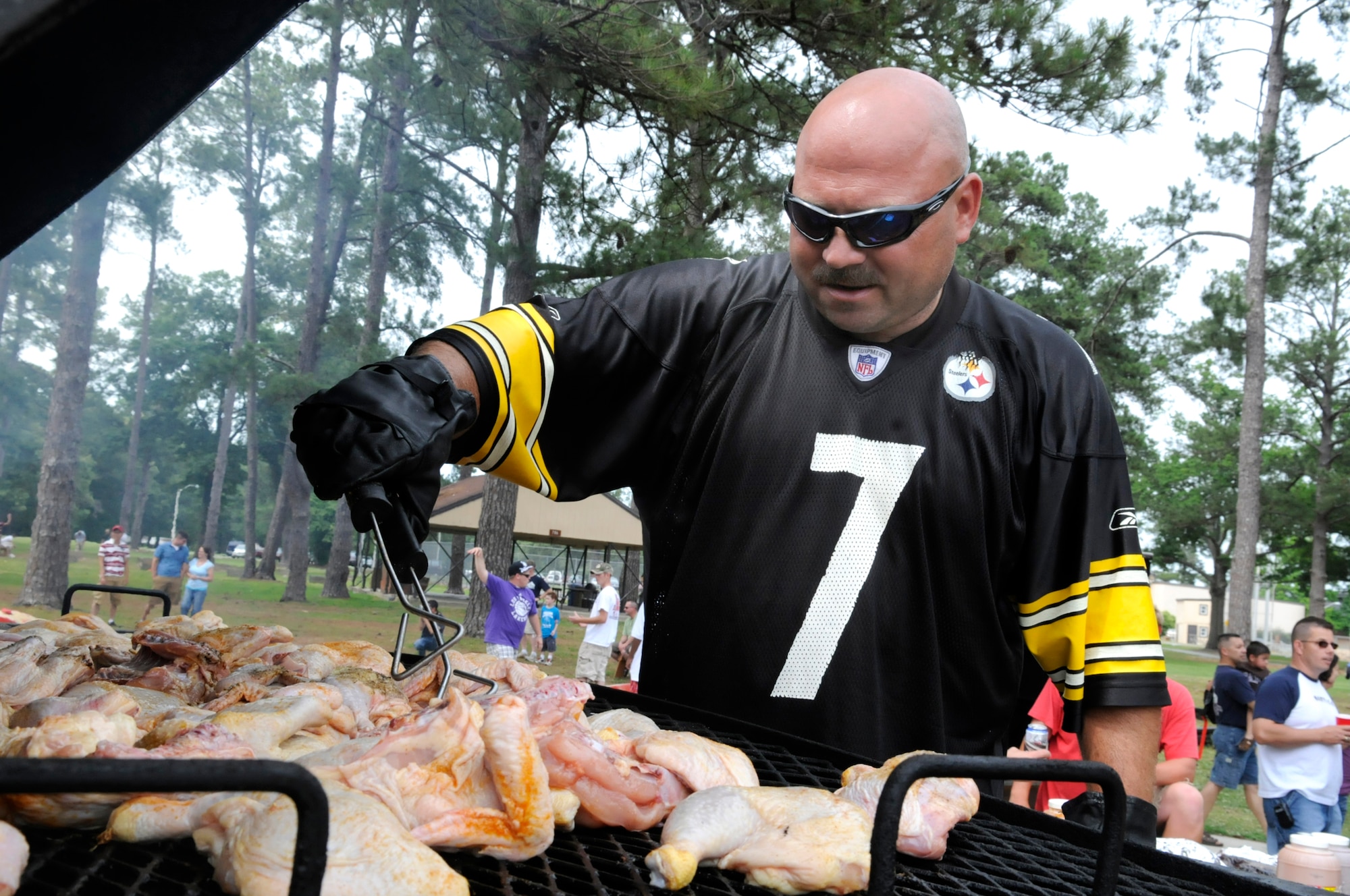 MSgt. Mark Denney cooks chicken on the grill for the 19th ARG picnic May 22. U. S. Air Force photo by Sue Sapp