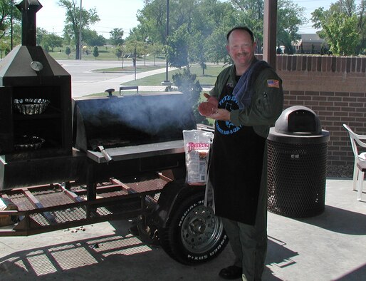 Master Sgt. John "Tex" Austin was busy serving up his "special" hamburgers and hot dogs during the May Unit Training Assembly.  After assuming chef duty for a fundraiser to benefit the Air Force Assistance Fund, Sergeant Austin again volunteered for the grill the next day during a going-away barbecue for the 931st's outgoing commander, Col. William T. Cahoon.  Besides being a boom operator and boom section noncommissioned officer in charge for the 18th Air Refueling Squadron, he is a building custodian, weapons custodian, enlisted performance review monitor and unit public affairs representative.  Sergeant Austin is scheduled to begin the seven-week Staff NCO Academy at Maxwell-Gunter Air Force Base, Ala., on June 2. (U.S. Air Force photo/2nd Lt. Gary Barbee)