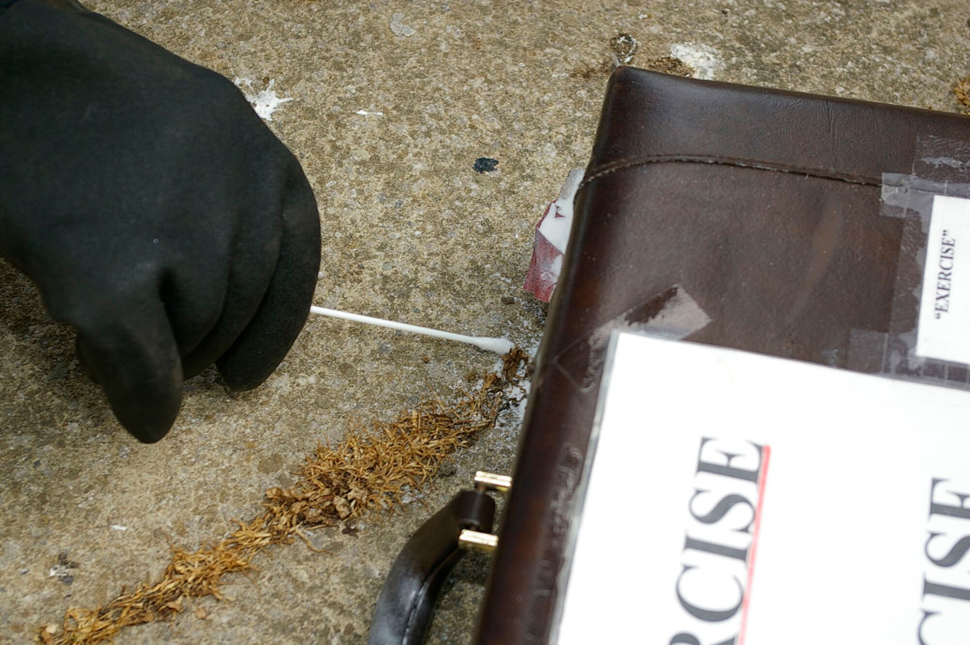 A sample of white powder is taken during the exercise May 23. (U.S. Air Force photo by Karen Abeyasekere)
