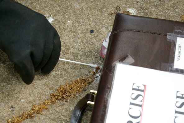 A sample of white powder is taken during the exercise May 23. (U.S. Air Force photo by Karen Abeyasekere)