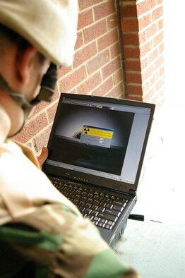 Airman 1st Class Jason Jeffers, 48th CES Explosive Ordnance Disposal, checks for signs of radiation on a package found during the training exercise for RAFs Mildenhall and Lakenheath responders. (U.S. Air Force photo by Karen Abeyasekere)