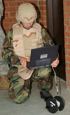 Airman 1st Class Jason Jeffers, RAF Lakenheath EOD, uses a laptop to check the X-rays of the suspicious package during a training exercise May 23. (U.S. Air Force photo by Karen Abeyasekere)