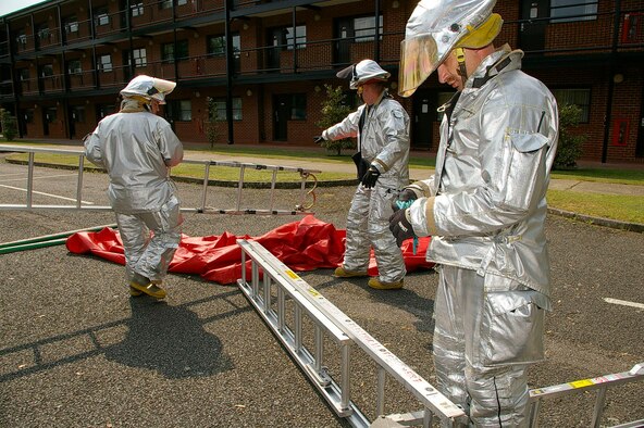 Firefighters from 100th CES Fire Department put together a decon area during the exercise May 23. (U.S. Air Force photo by Karen Abeyasekere)