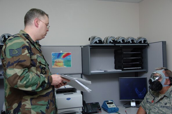 Tech. Sgt. John E. Sutton Jr. evaluates the gas mask fitting of Senior Master Sgt. Mack Housman during the May Unit Training Assembly.  Sergeant Sutton, a bioenvironmental engineering craftsman for the 931st Aerospace Medicine Flight, is scheduled to retire from the Air Force Reserve in June.  Sergeant Housman is the superintendent of the 931st's Military Personnel Flight. (U.S. Air Force photo/Senior Airman Connor Burkhard)