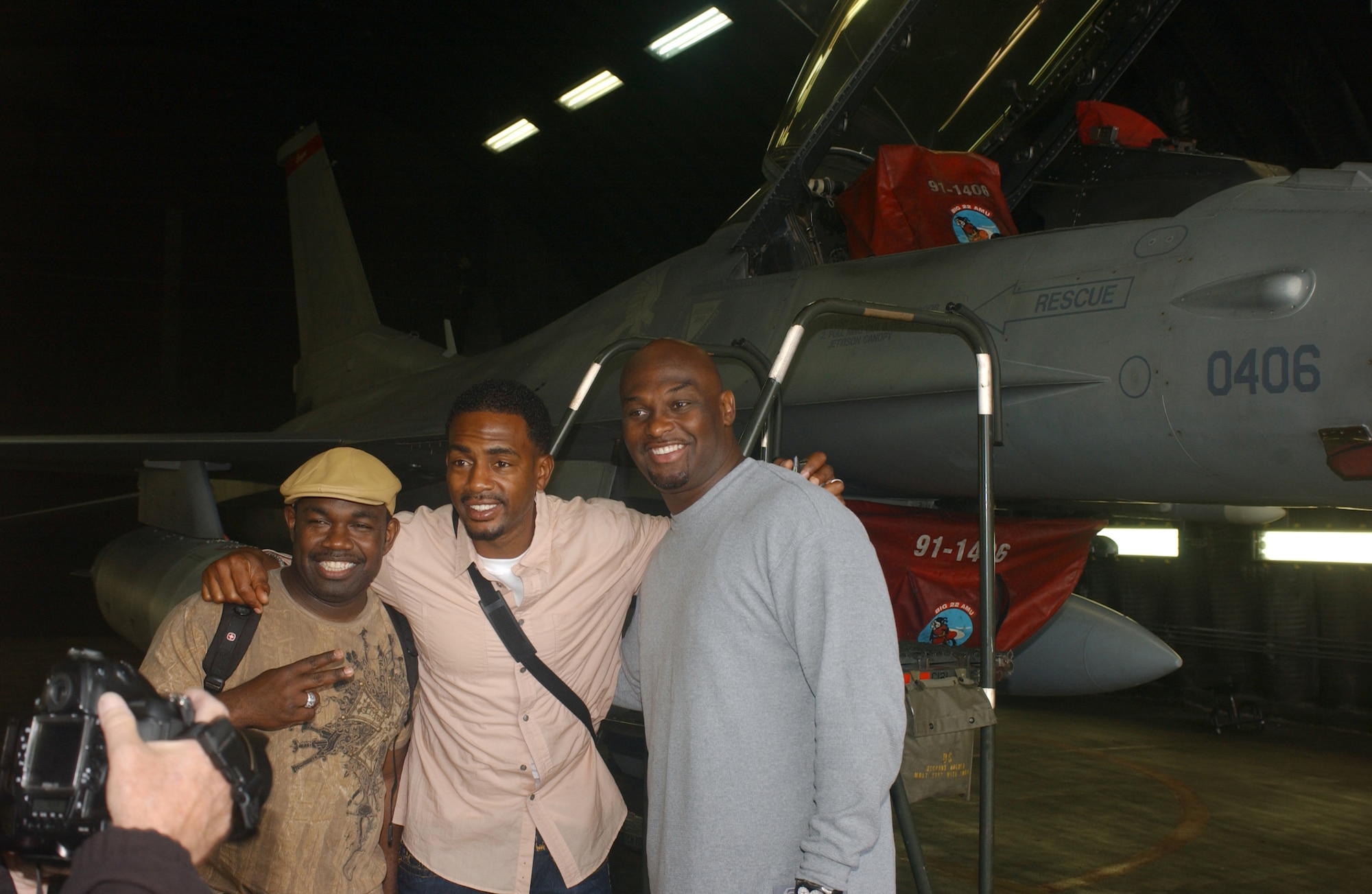 SPANGDAHLEM AIR BASE, Germany -- Rodney Perry, Bill Bellamy and Tommy Ford pose for pictures in front of an F-16 from the 22nd Fighter Squadron May 27, 2008.  The trio’s performance here later that evening was the final stop on their first USO tour to Germany. U.S. Air Force photo by Master Sgt. Alexander R. Ray