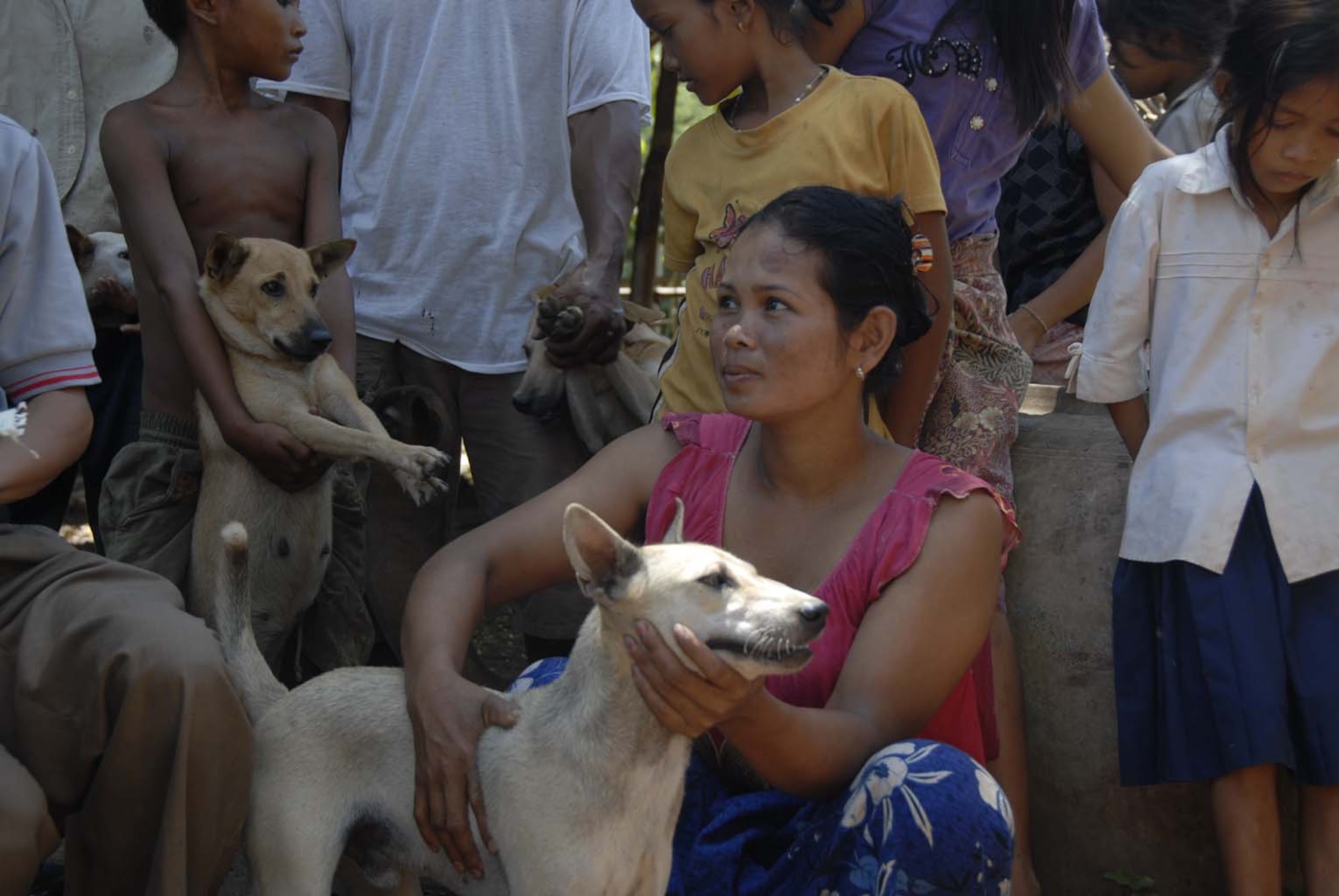 KAMPONG CHAM PROVINCE, Cambodia – Villagers at Kos Ta Phen a rural village five kilometers off the paved road in Kampong Cham Province wait patiently for there dogs to be vaccinated for rabies and treated for worms from the Veterinary staff of Pacific Angel. A team of three U.S. total force Veterinarians travel to a new location in the province each day of Operation ‘Pacific Angel 01-08’, a joint/combined 13th Air Force-led humanitarian assistance operation May 25 - 29. (U.S. Air Force photo/Tech. Sgt. Tom Czerwinski)