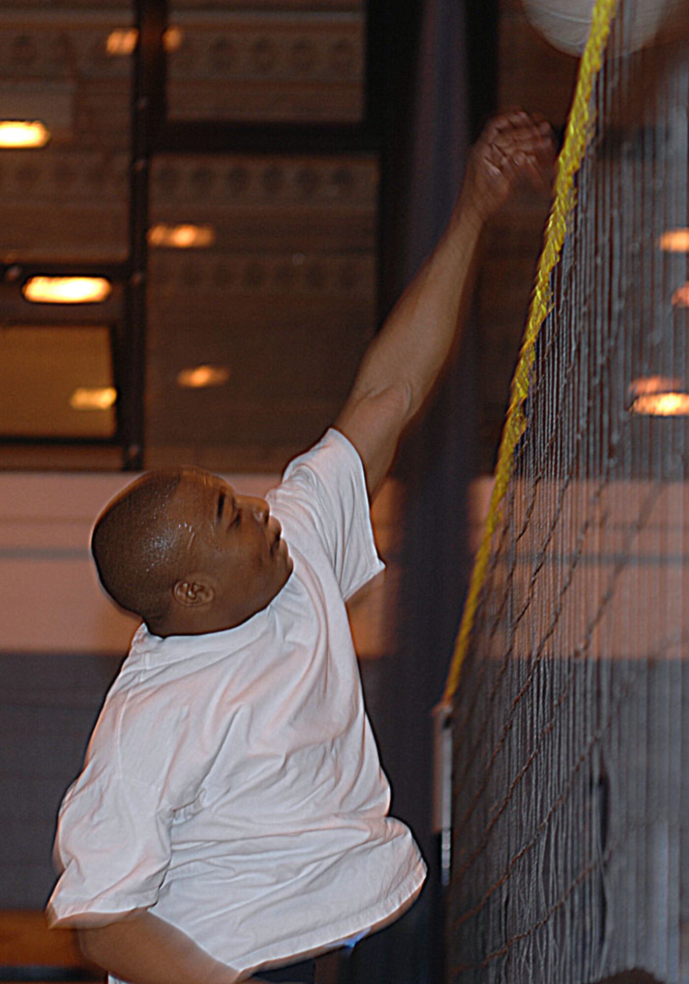 While playing for Airmen Committed to Excellence team, Airman 1st Class Brad Smith spikes the ball returning it to the Team 5/6 players during a recent Enlisted Professional Organizations warrior challenge. Team 5/6 won the tournament. Quarterly, members of each Enlisted ProOrg compete in various events to promote bonding through competition and the right to claim a traveling cricket bat and bragging rights for their respective organization. (U.S. Air Force photo by Master Sgt. Sarah Frankenhoff)