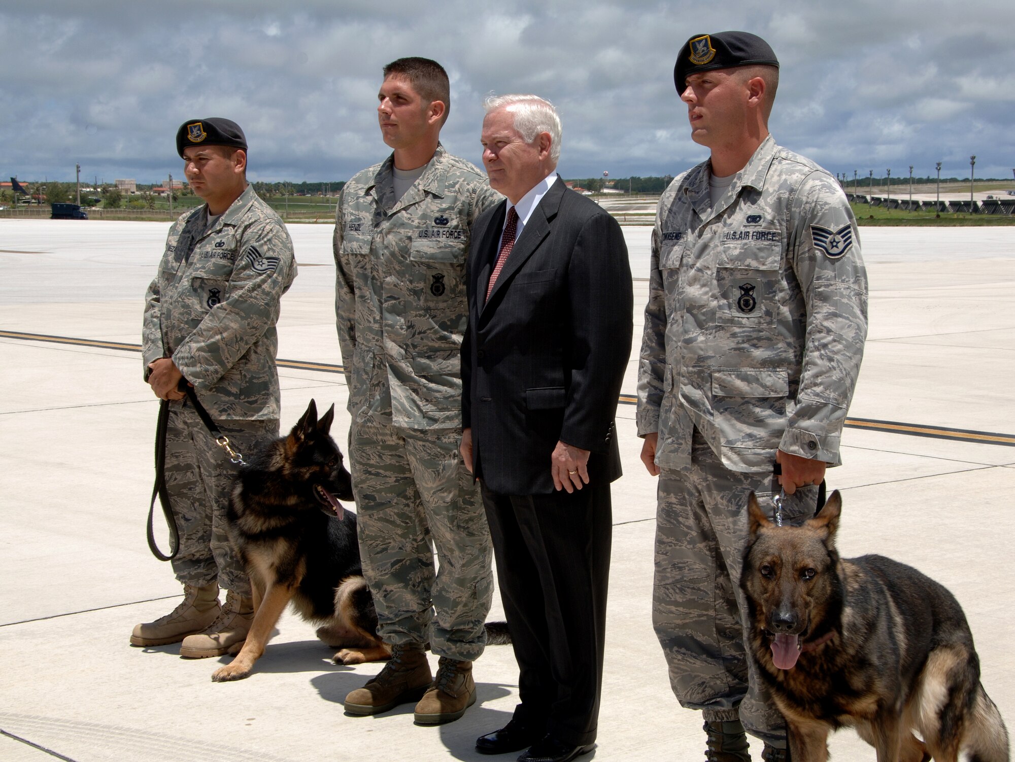 Secretary of Defense Dr. Robert Gates poses with Airmen from the 36th Security Forces Squadron K-9 unit before departing Andersen Air Force Base on May 30. Andersen was Dr. Gates' first stop in his week-tour of the Asia-Pacific region.  During his trip to Andersen, Dr. Gates also met with military and local government officials to discuss Guam's strategic importance in the region and the reallocation of forces throughout the Pacific. (U.S. Air Force photo by Airman 1st Class Courtney Witt)   