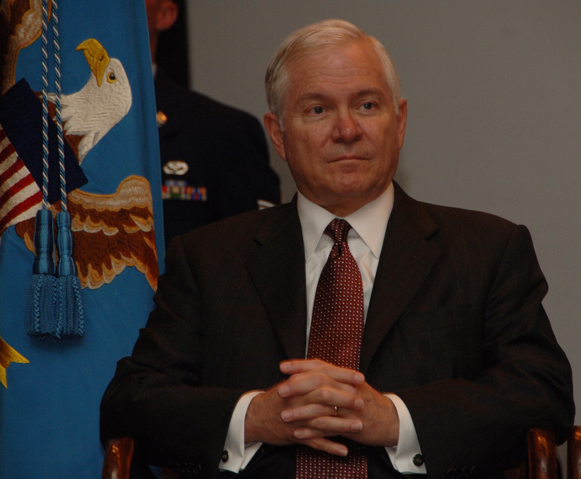The Secretary Of Defense, Dr. Robert Gates   listens as guest speaker, Governor Felix Camacho thanks Seikichi Kaneshiro, "Mr. Paul", for his dedicated service to the Nation at Andersen Air Force Base on May 30. Mr. Robert Gates presided over the Retirement Ceremony in honor of Mr. Paul's sixty-six years of Military and Civil Service. (U.S. Air Force by Airman 1st Class Courtney Witt)   