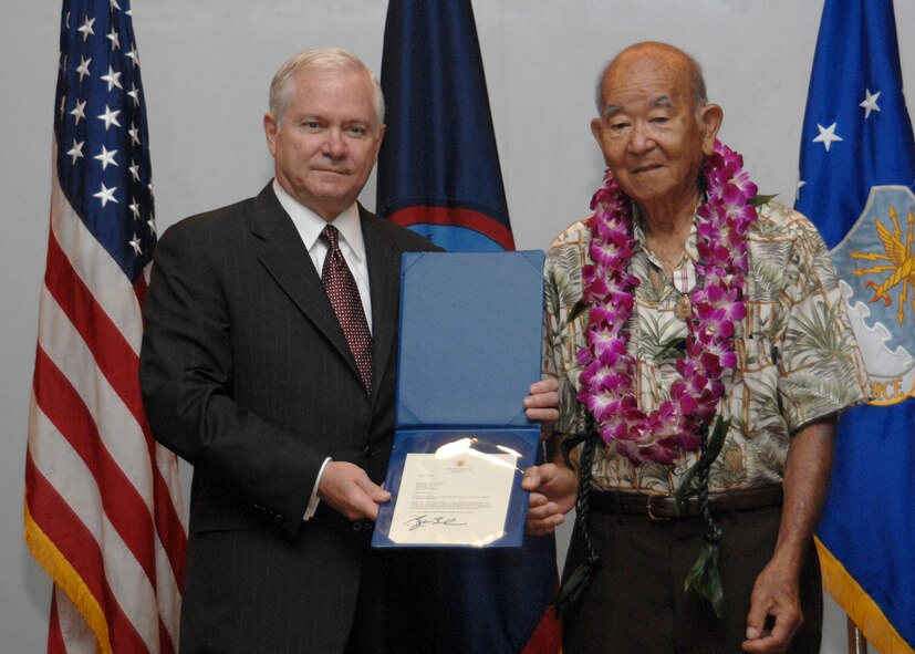 Secretary of Defense Dr. Robert Gates presents Mr. Seikichi "Mr. Paul" Kaneshiro with the Outstanding Civilian Career Service Award May 30 at Andersen Air Force Base, Guam, on behalf of President George W. Bush for his dedicated service to the nation and the U.S. Air Force. Mr. Paul has served in both the military and civil service for sixty-six years spanning from Jan. 28, 1946 to June 2, 2008. His service includes support to the Cold War, the Korean War and Vietnam War, Operations Desert Shield and Desert Storm and The Global War On Terror.  (U.S. Air Force photo by Airman 1st Class Nichelle Griffiths)   