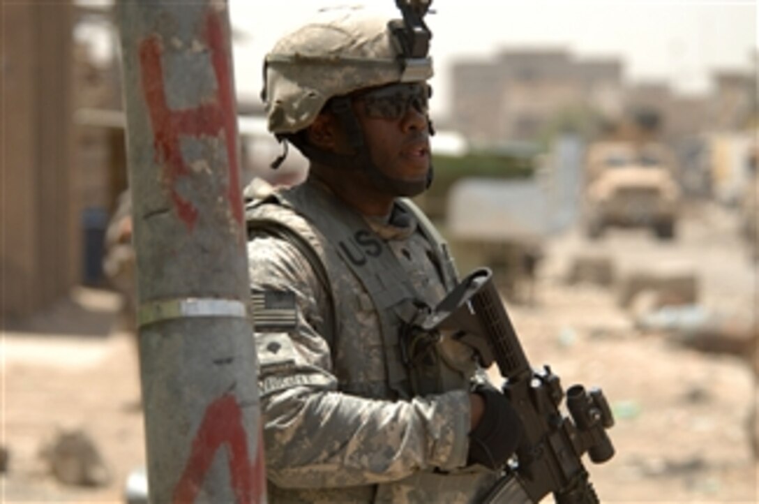 U.S. Army Spc. Marcus Wright from Headquarters Troop, 3rd Special Troops Battalion, provides security during a patrol at Jamilla Market in the Sadr City district of Baghdad, Iraq, on May 15, 2008.  Wright and his unit are deployed from Fort Carson, Colo.  