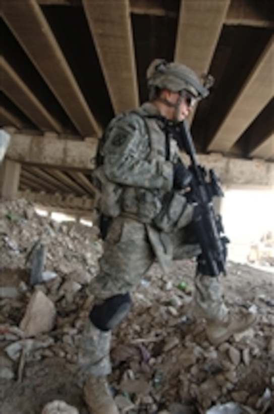 U.S. Army Pfc. John Rozonewski from Alpha Troop, 3rd Squadron, 89th Cavalry Regiment, 4th Brigade Combat Team, 10th Mountain Division, stands watch under a bridge during a patrol outside Forward Operating Base Loyalty, Iraq, on May 26, 2008.  