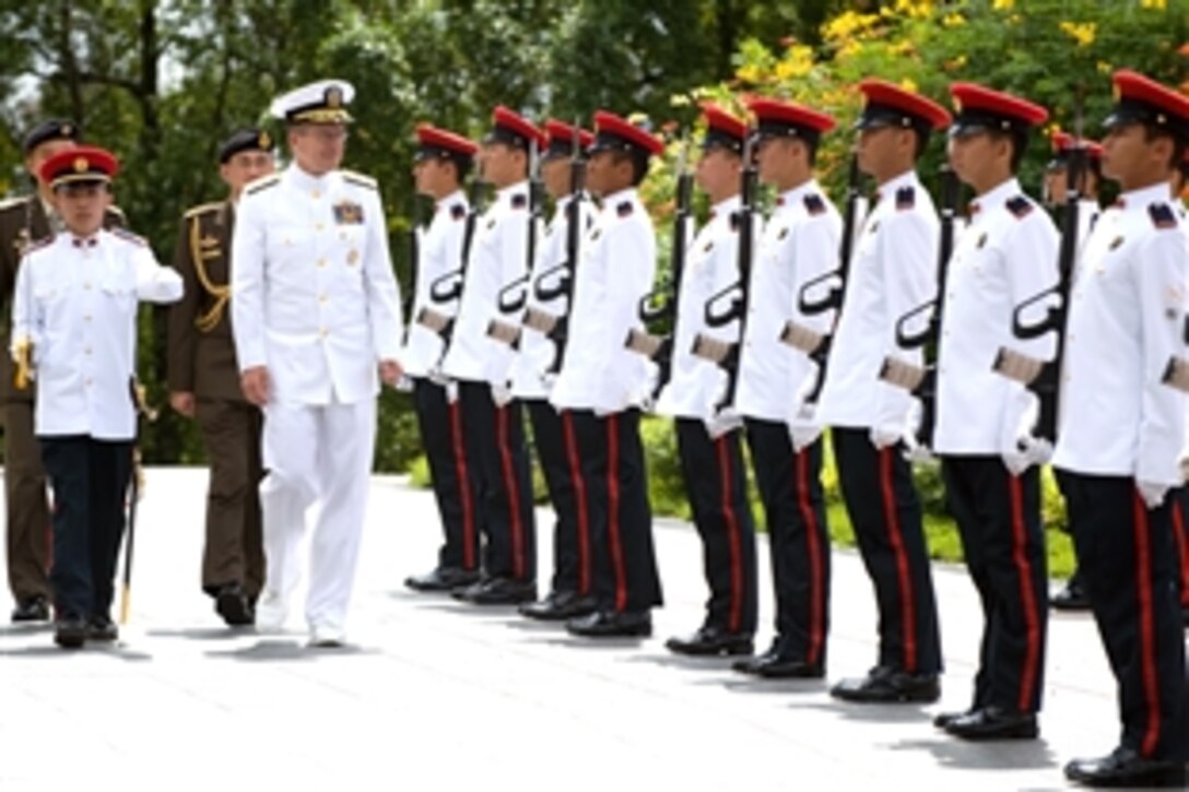 U.S. Navy Adm. Mike Mullen, center, chairman of the Joint Chiefs of Staff, reviews the Singapore armed forces during a welcoming ceremony at Istana, the official presidential residence, May 29, 2008.  Singapore is Mullen's second stop on an eight-day tour visiting Asian-Pacific nations and attending the 2008 Shangri-La Dialogue hosted by the island nation. 