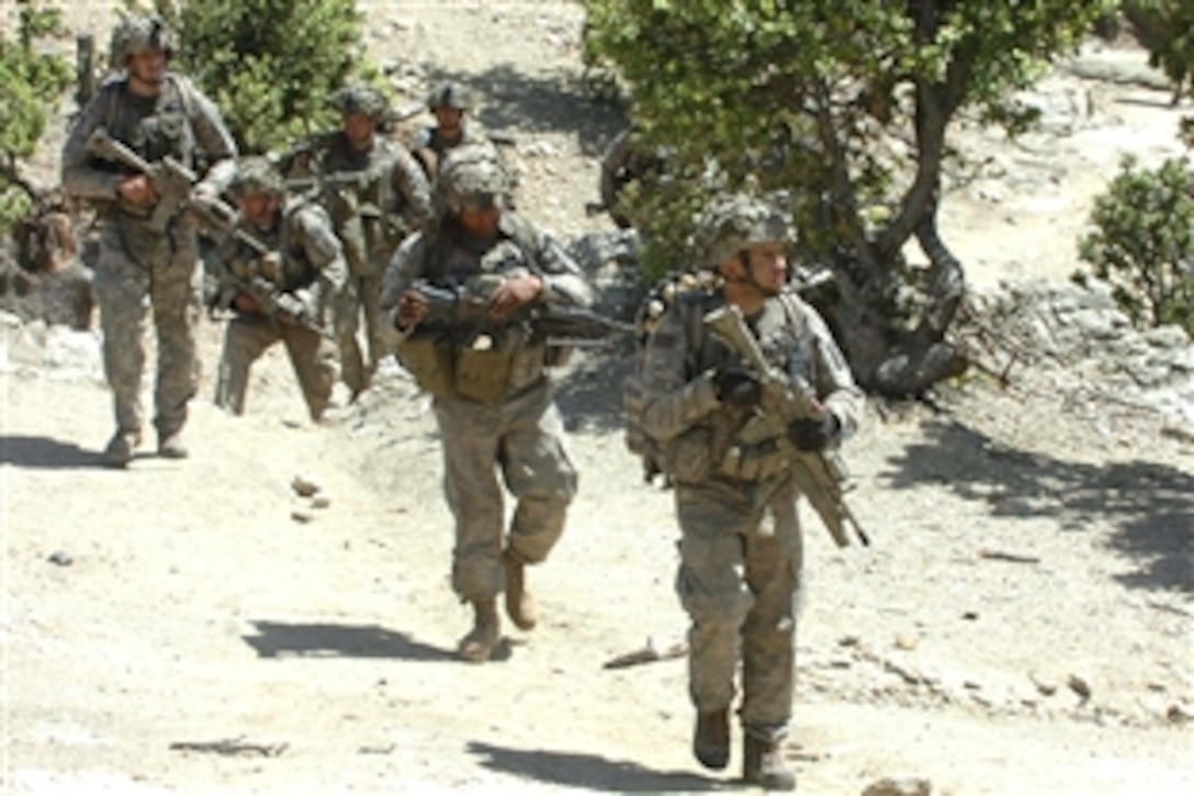 U.S. soldiers move out to assist Afghanistan National Army soldiers in searching several suspicious structures for weapons caches in the Narang Valley, Kunar province, Afghanistan, May 18, 2008. The soldiers are assigned to Company A, 2nd Battalion, 503rd Infantry Regiment. 