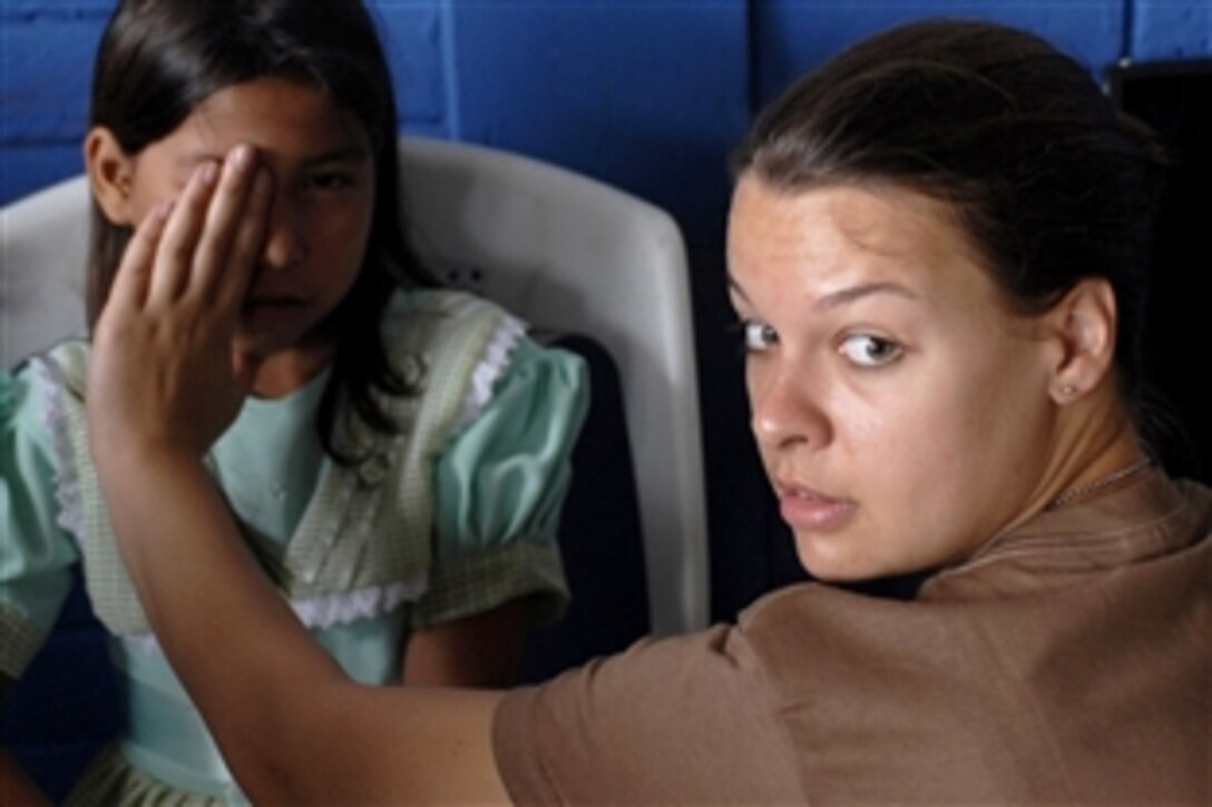 U.S. Navy Lt. Megan Rieman gives a Salvadoran girl an eye exam at the Canton la Sunza school during Operation Continuing Promise 2008, a multinational humanitarian project involving the United States, El Salvador, Guatemala and Peru, May 26, 2008. Rieman is assigned to the USS Boxer, which is supporting the community relations mission.