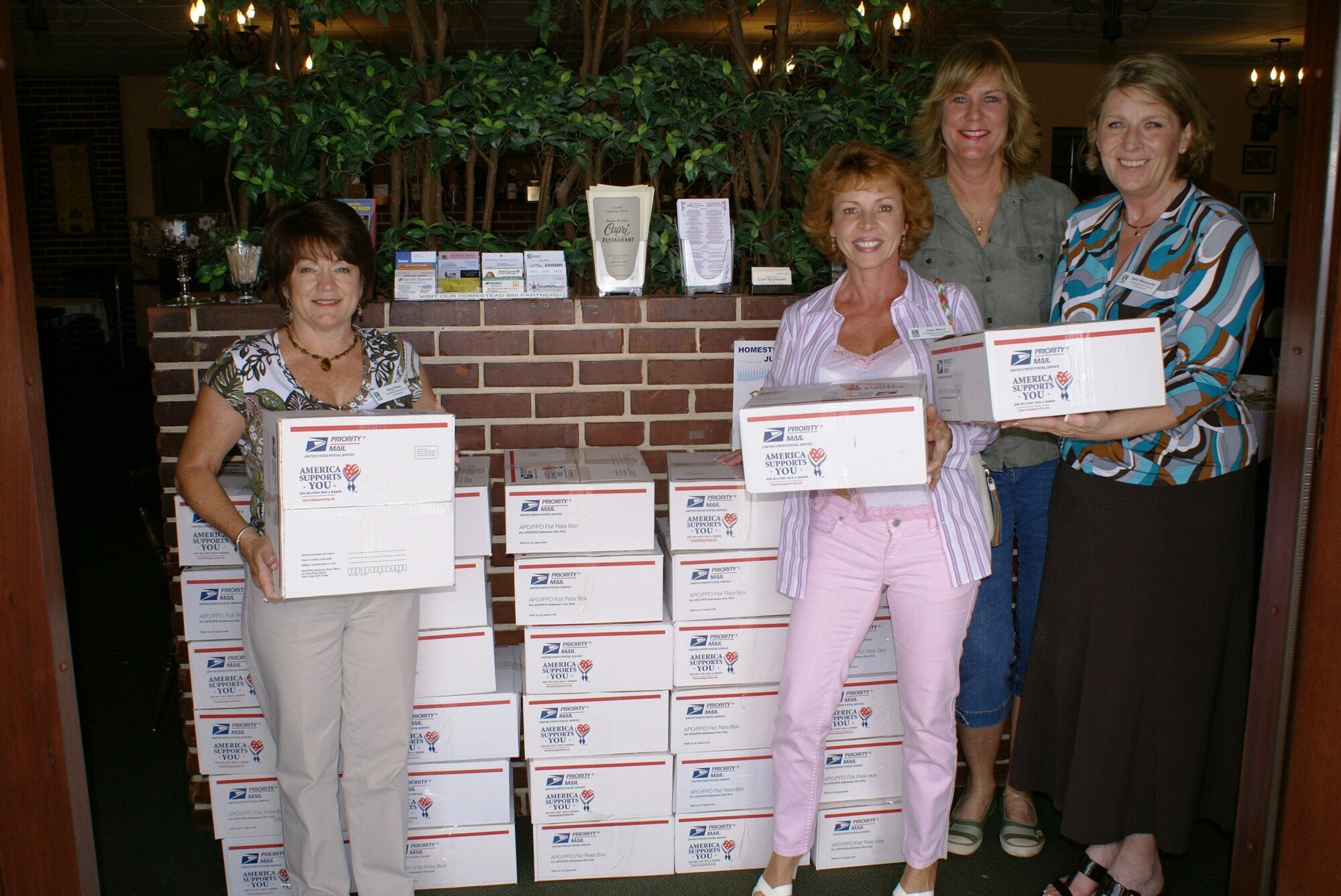 Members of Soroptimist International, Homestead, Fla., prepare to ship care packages to the 482nd Security Forces Squadron reservists currently deployed to Kirkuk Air Base, Iraq, on May 26. Over $1,600 was raised from various fundraisers to purchase items for each package. Contents include: books, CDs, snacks, clothing, and other specific items requested by the Airmen. Each package also includes a personal letter from club members expressing their appreciation for protecting our freedom. With over 90,000 members in 120 countries, Soroptimist is a service organization for executive and professional women providing volunteer services to their communities.  (U.S. Air Force photo/Tim Norton)