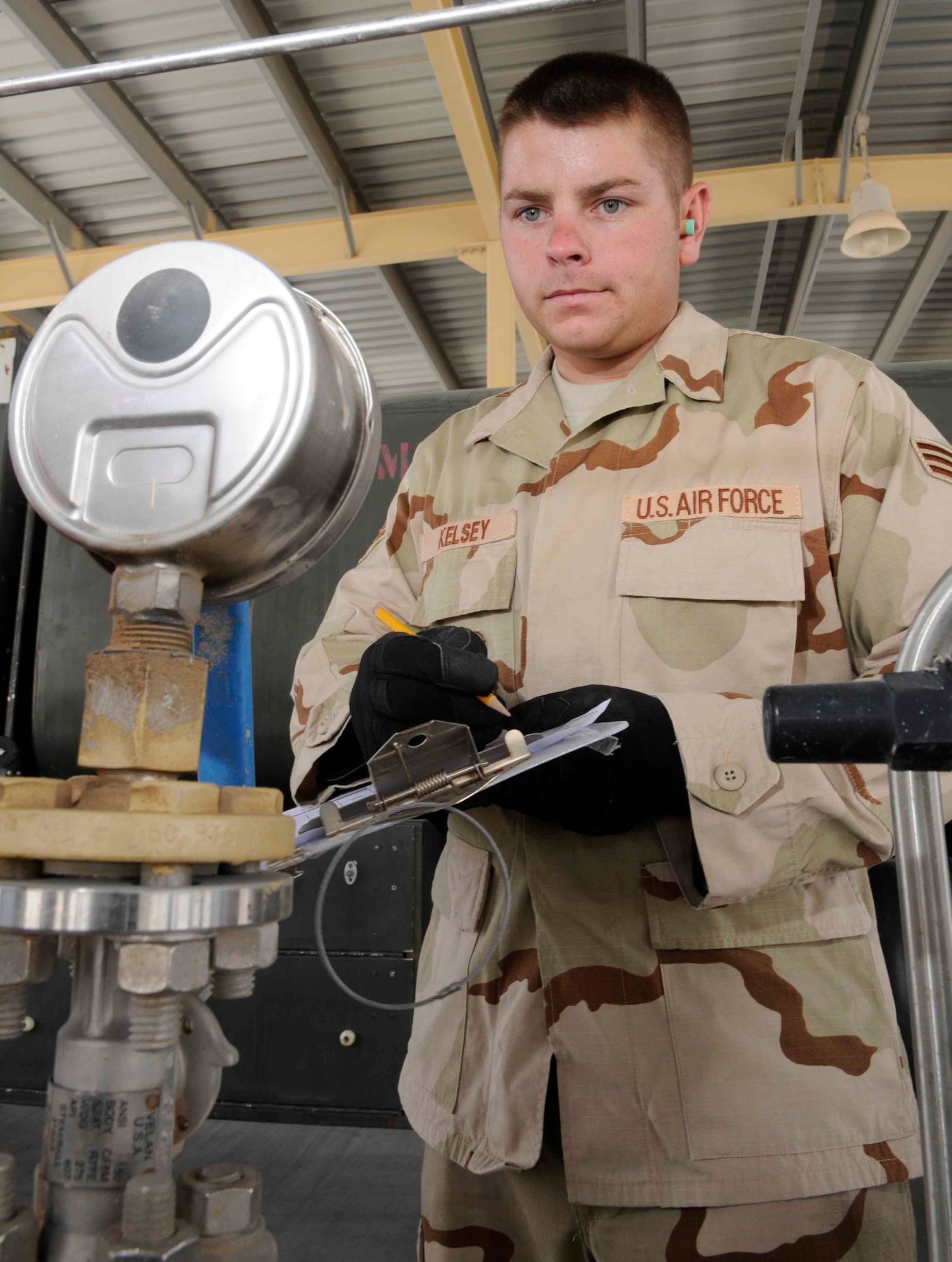SOUTHWEST ASIA--Senior Airman Joshua Kelsey keeps on eye on a pressure gauge to document the amount of fuel pumped. He keeps a log of how much fuel is pumped into his truck daily. (U.S. Air Force photo/Tech. Sgt. Johnny Saldivar.)