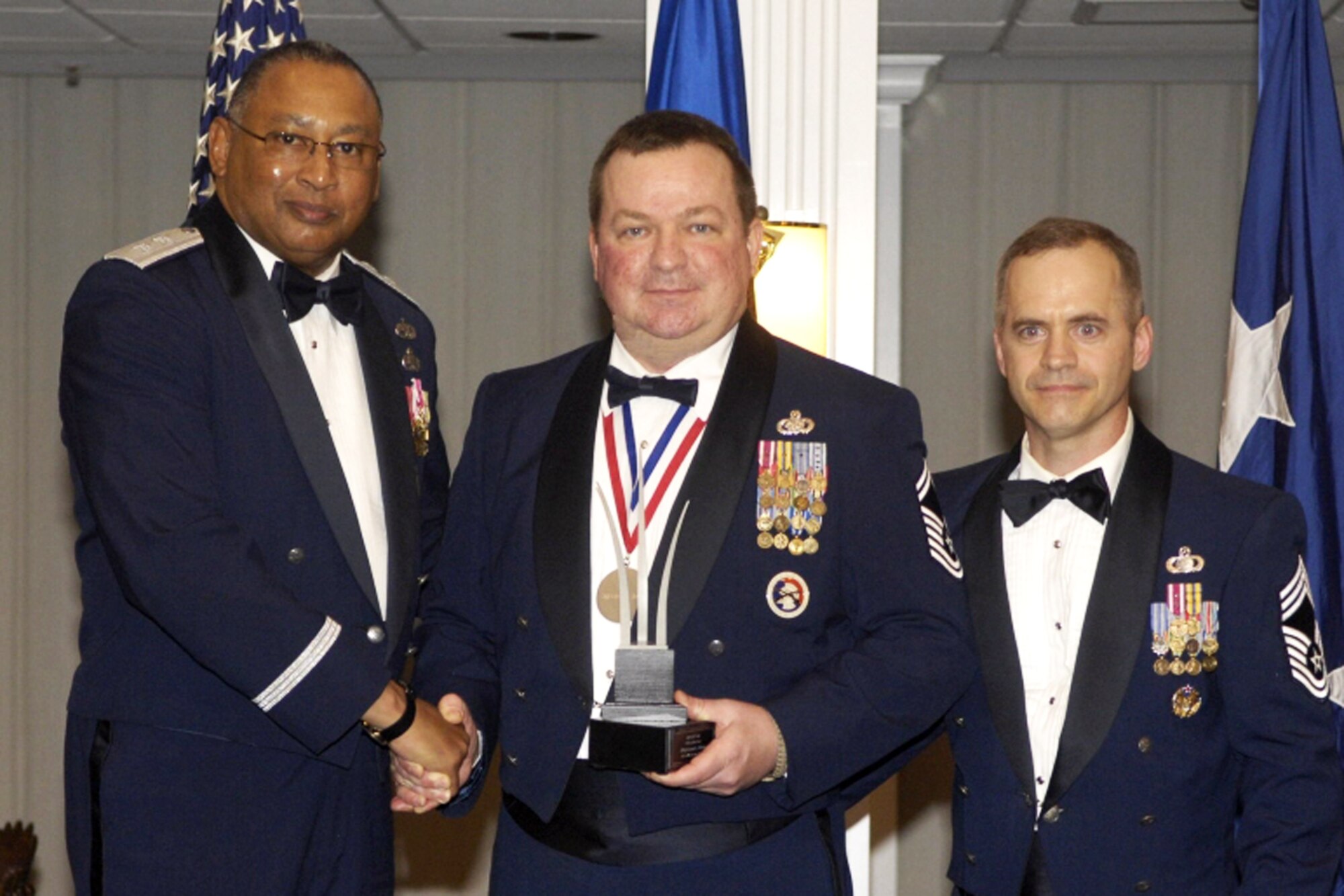 WASHINGTION, D.C. -- Senior Master Sgt. Robert Moore, center, is presented the Air Reserve Component Fuels Senior Noncommissioned officer of the Year Award for 2007, by Maj. Gen. Gary T. McCoy, left, director of logistics readiness, Office of the Deputy Chief of Staff for Logistics, Installations and Mission Support, HQ USAF; and Chief Master Sgt. Scott Baker, the fuels manager, Air Staff, HQ USAF. (U.S. Air Force photo)