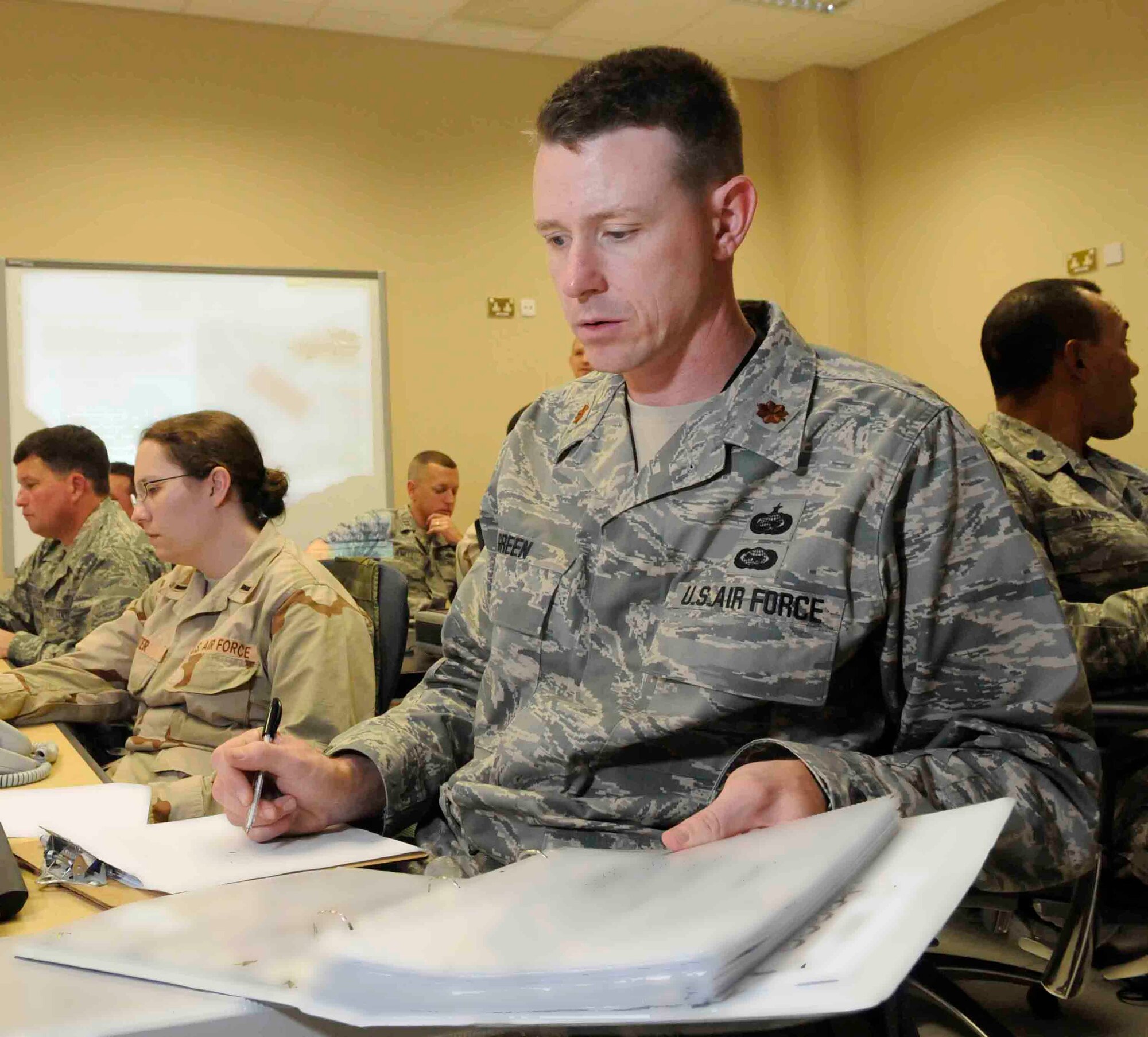 SOUTHWEST ASIA--Major Marshall Green, 379th Expeditionary Force Support Squadron, prepares to coordinate accountability during an airbase exercise at a Southwest Asia air base May 26.  Major Green will coordinate with his unit control center to ensure every member of his squadron is accounted. Major Marshall is originally from Kansas City, Kan. and deployed from Randolph Air Force Base, Texas.  (U.S. Air Force photos/Tech. Sgt. Johnny Saldivar)