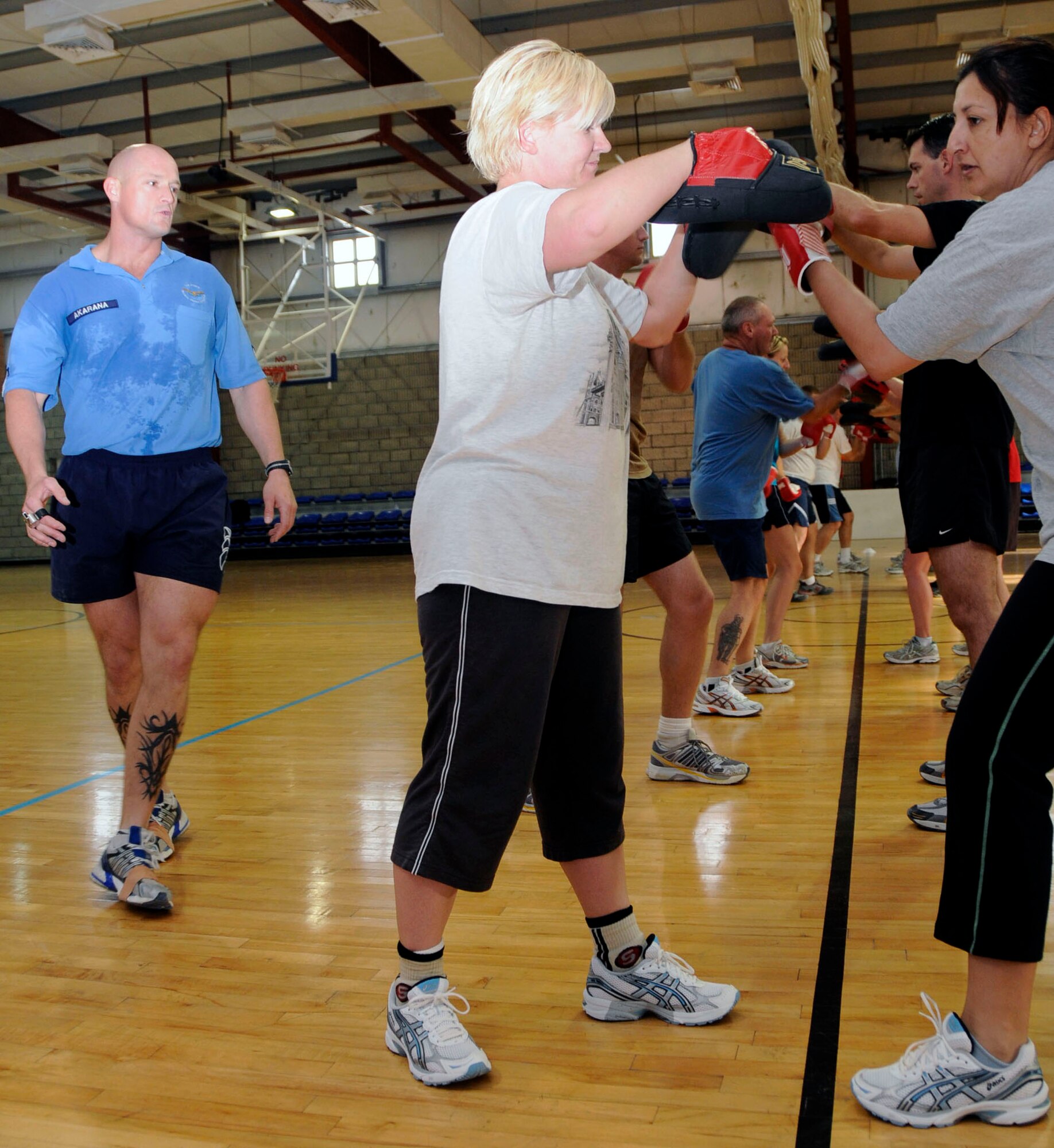 SOUTHWEST ASIA -- RAAF PTI Cpl Jason "Akas" Akarana (left) gives instructions to base members participating in his kickboxing aerobics course. (U.S. Air Force photo by Senior Airman Domonique Simmons)