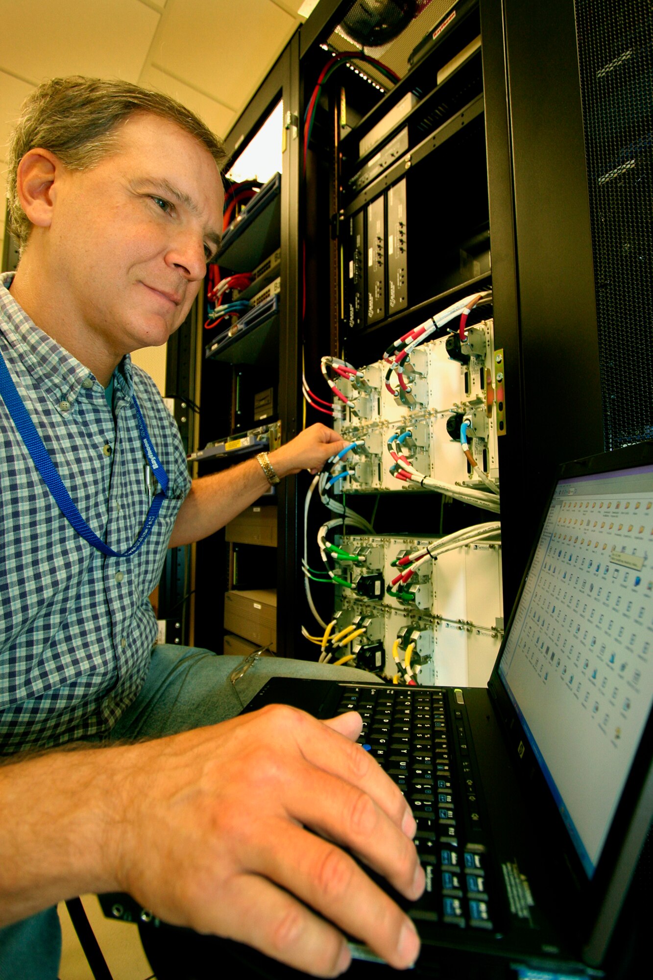 GRISSOM AIR RESERVE BASE, Ind.,-- Rick Gabrieli, system specialist with Raytheon Technical Services, works on network configurations used in Grissom's new Radar Approach Control facility scheduled to open in September. (U.S. Air Force Photo/Tech. Sgt. Patrick M. Kuminecz) 