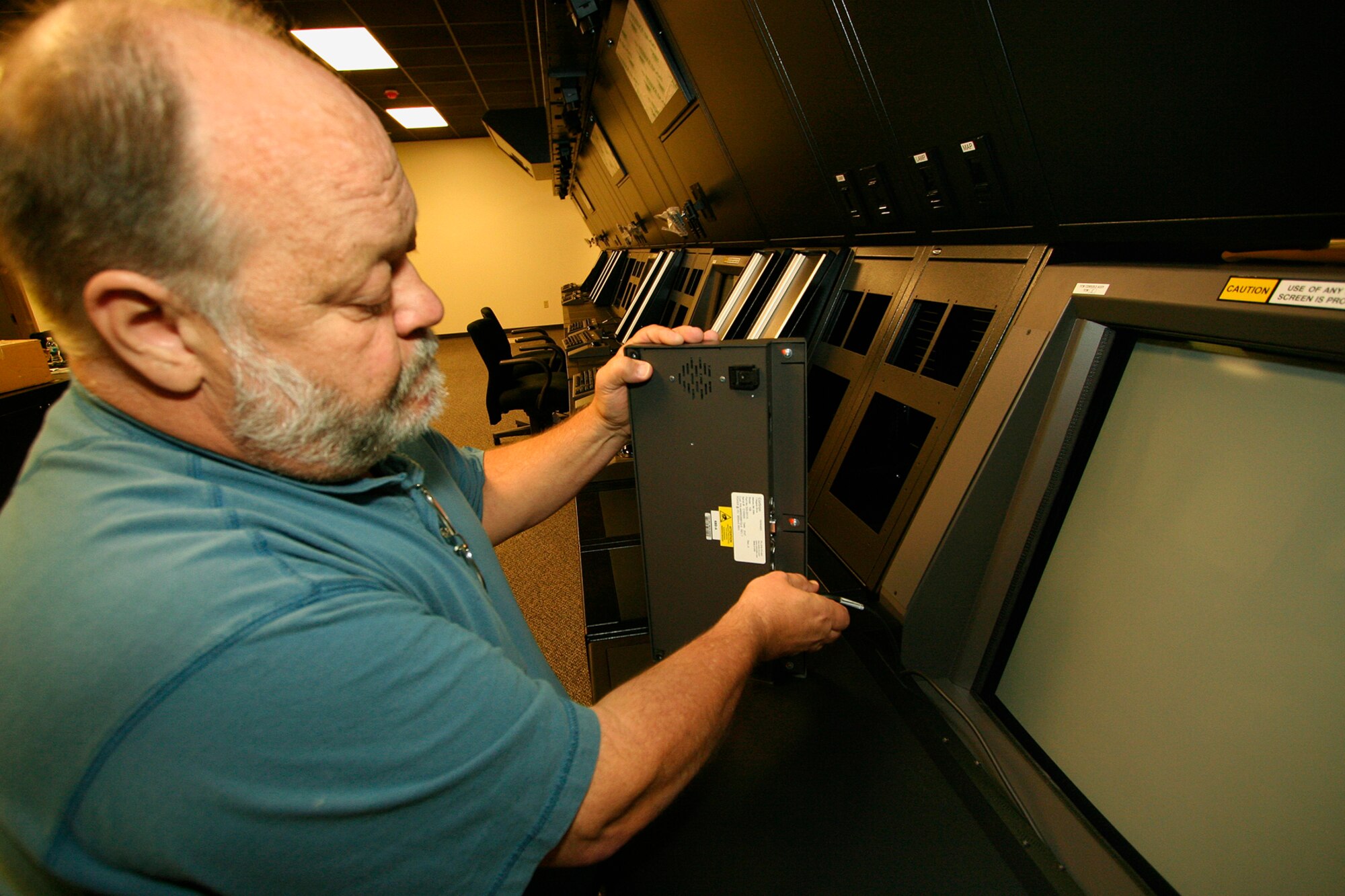 GRISSOM AIR RESERVE BASE, Ind., --  Mark Bintliff, installation team lead, installs a keyboard at one of the terminal controller stations in the new Radar Approach Control  facility.  The new RAPCON building is scheduled to be up and running in September.  (U.S. Air Force Photo/Tech. Sgt. Patrick M. Kuminecz)