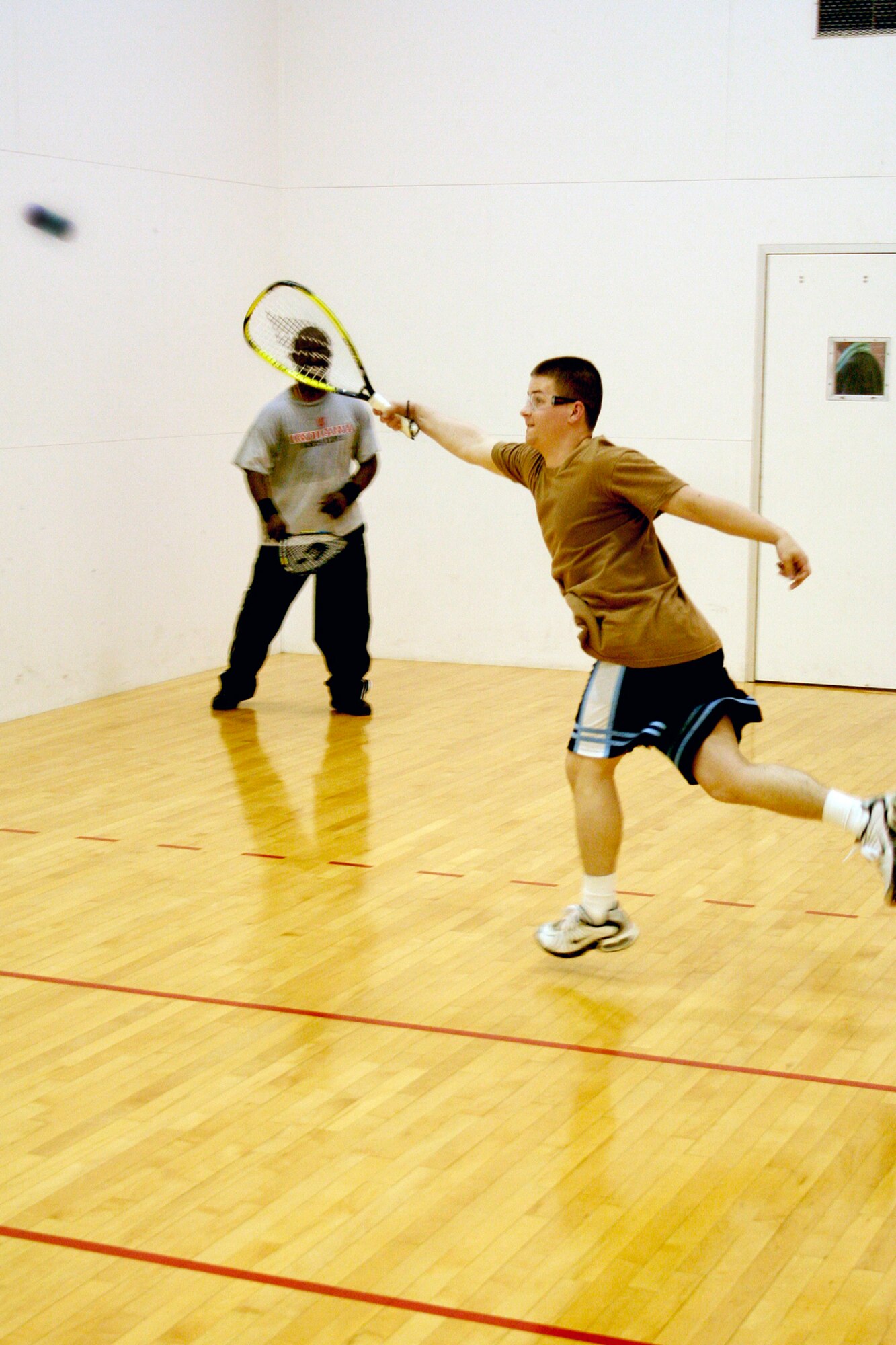 GRISSOM AIR RESERVE BASE, Ind.,-- Senior Airman Joe Smith, emergency management technician, 434th Civil Engineering Squadron, attempts to intercept a shot from his opponent, Tech. Sgt. Abraham Spencer (background), jet engine technician, 434th Maintenance Squadron, during a racquetball tournament held during a recent unit training assembly.  Sergeant Spencer was the victor in this match defeating Airman Smith 21-10 to advance to the next round.  (U.S. Air Force Photo/Tech. Sgt. Patrick  Kuminecz)
