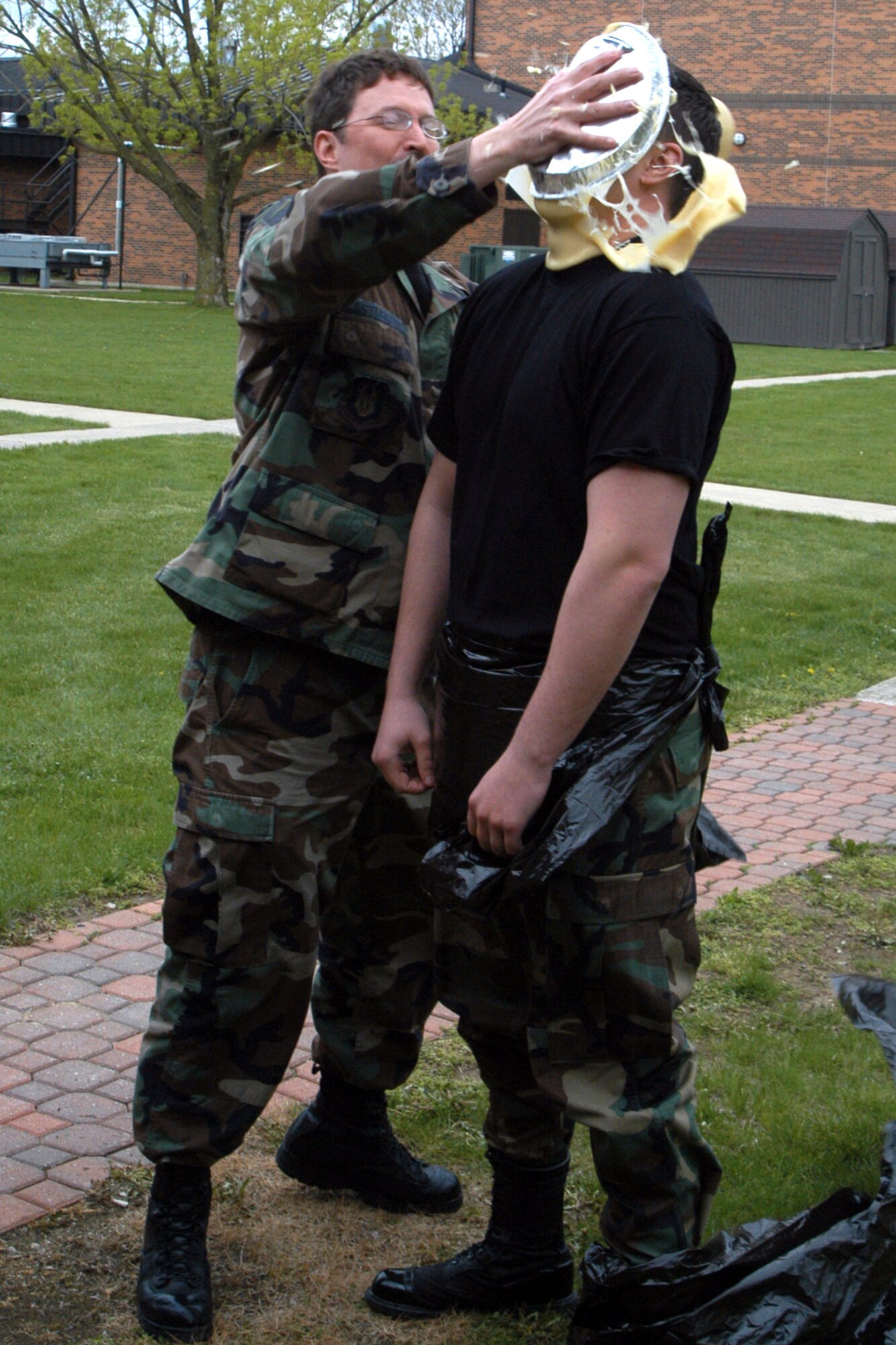 GRISSOM AIR RESERVE BASE, Ind., -- Senior Master Sgt. Jeff Castleberry, a medical administrator with the 434th Aerospace Medicine Squadron, plasters a pie in the face of  Tech. Sgt. Steven Kulik, an aerospace medical technician.  Sergeant Castleberry was the winner of an auction that allowed the highest bidder to place a pie in the face of a selected Airman.  Funds raised by the event will be used for the clinic's annual Christmas party. (Air Force photo/Senior Airman Ben Mota)