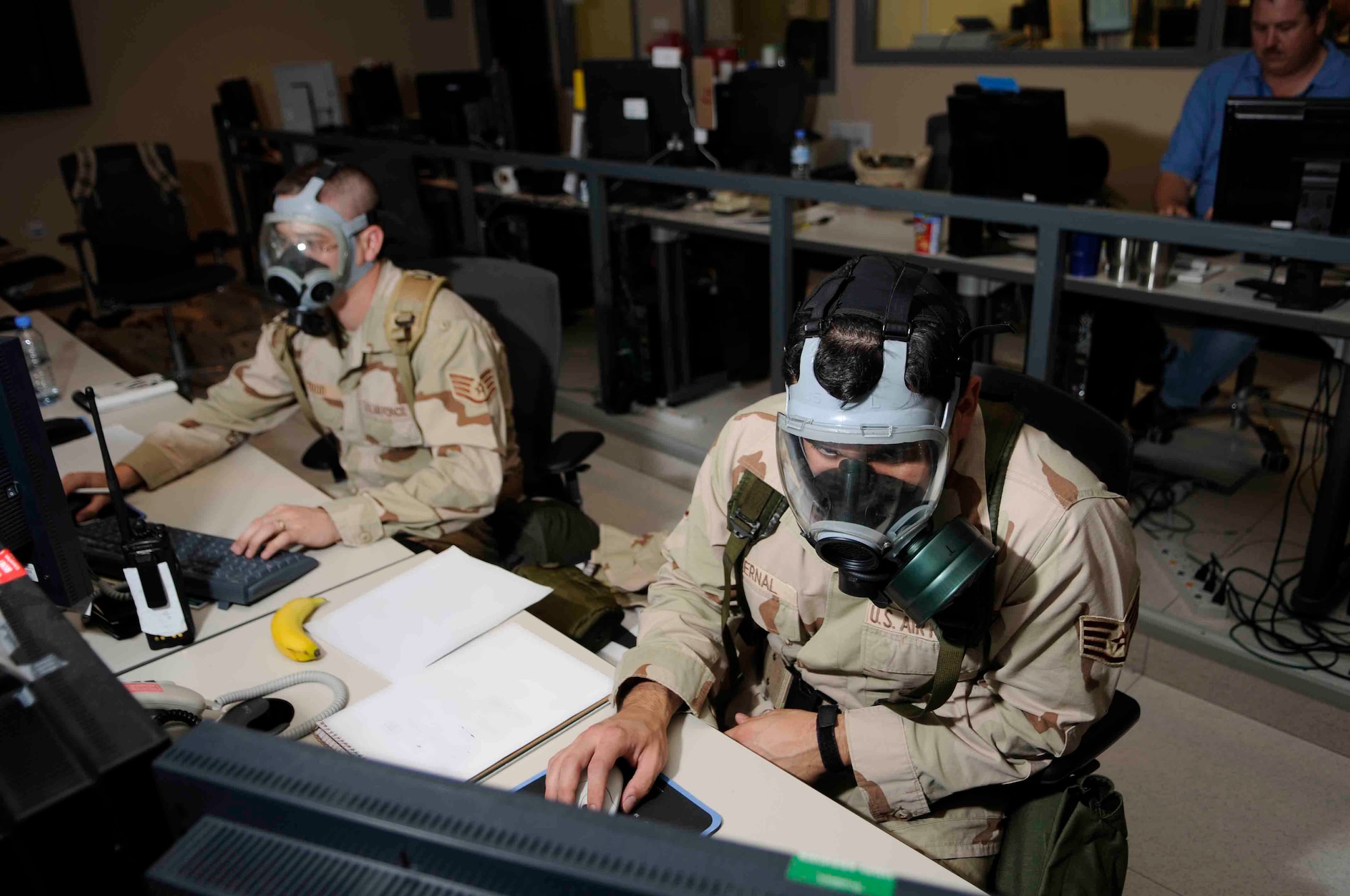 SOUTHWEST ASIA--Staff Sgts. Nicholas Todd and David Bernal, right, 379th Expeditionary Maintenance Operations Squadron, track aircraft during an airbase defense exercise at a Southwest Asia air base May 26.  They both keep the flight line informed of exercise inputs, and ensure group and wing leadership are informed of all aircraft status and location. Sergeant Bernal is originally from Miami, Fla. and deployed from MacDill Air Force Base, Fla.  Sergeant Nicholas is originally from Arlington Heights, Ill. and deployed from Ellsworth Air Force Base, S.D. (U.S. Air Force photos/Tech. Sgt. Johnny Saldivar)