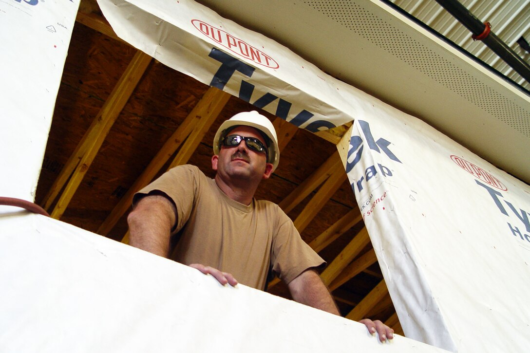 GALLUP, N.M., -- Senior Master Sgt. Glenn Johnson, 434th Civil Engineer Squadron, looks out the window of a house he and others in his unit are constructing for the Southwest Indian Foundation. Twenty-seven civil engineers from Grissom ARB are currently deployed to New Mexico and working under the auspices of the innovative readiness program.  (U.S. Air Force photo/Senior Master Sgt. Chuck Gill)                    