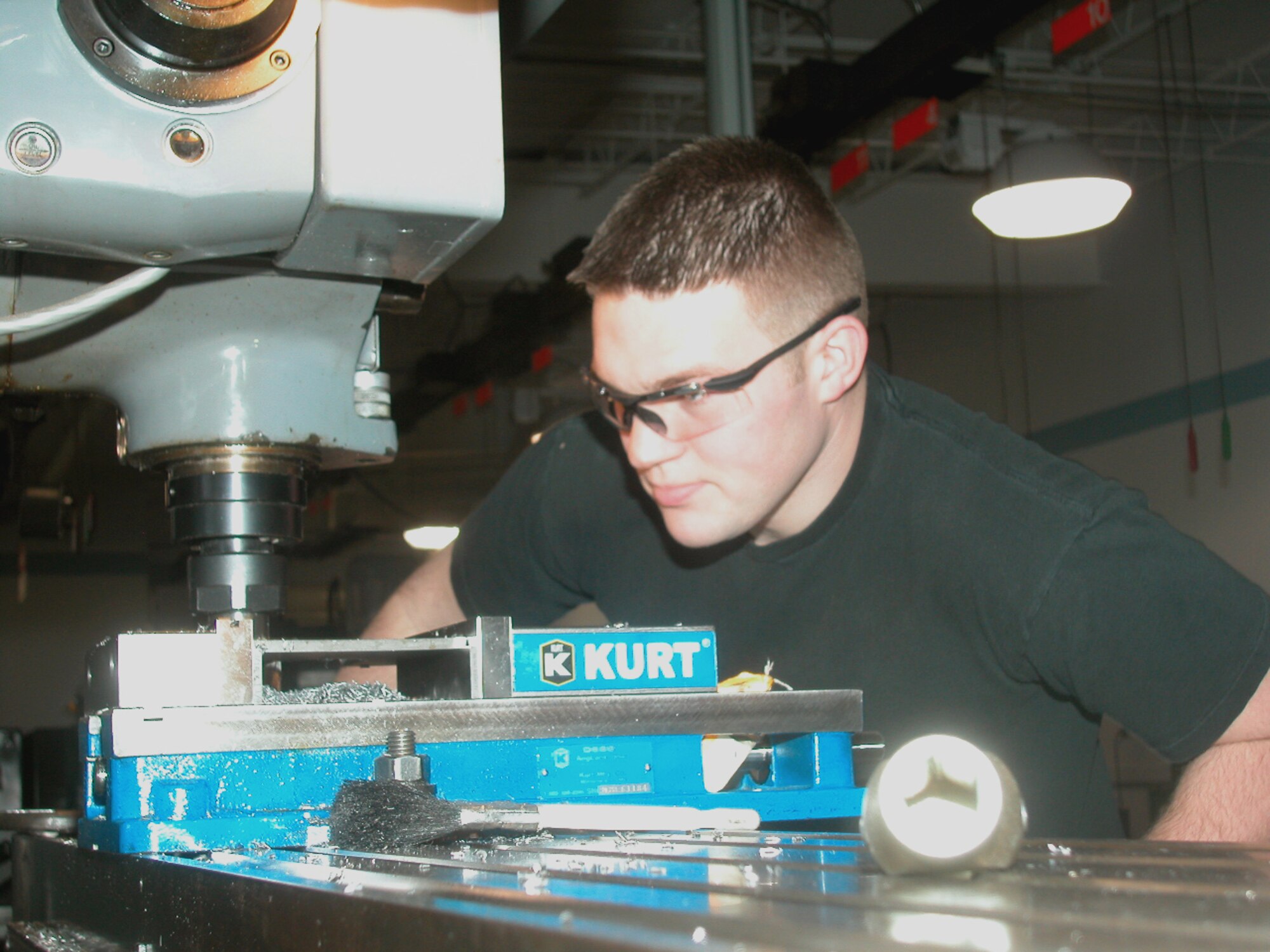 GRISSOM AIR RESERVE BASE, Ind., -- Staff Sgt. Charles Coyne, 434th ARW Maintenance Squadron, operates a Bridgeport milling machine to manufacture a guide plate, while wearing the appropriate eye protection.  Using the proper safety equipment, including proper eye protection, is critical to Air Force mission.   Statistics show that during each working day more than 2,000 workers in the U.S. suffer job-related eye injuries, with 10 to 20 percent of them classified as disabling because of temporary or permanent vision loss.  Ninety percent of these injures could be prevented with the correct protective eyewear.  Lt. Col. Ricardo Salvat, officer in charge of the Grissom optometry clinic warns everyone to "remember that eye safety is no accident." (Air Force photo/Senior Airman Chris Bolen)