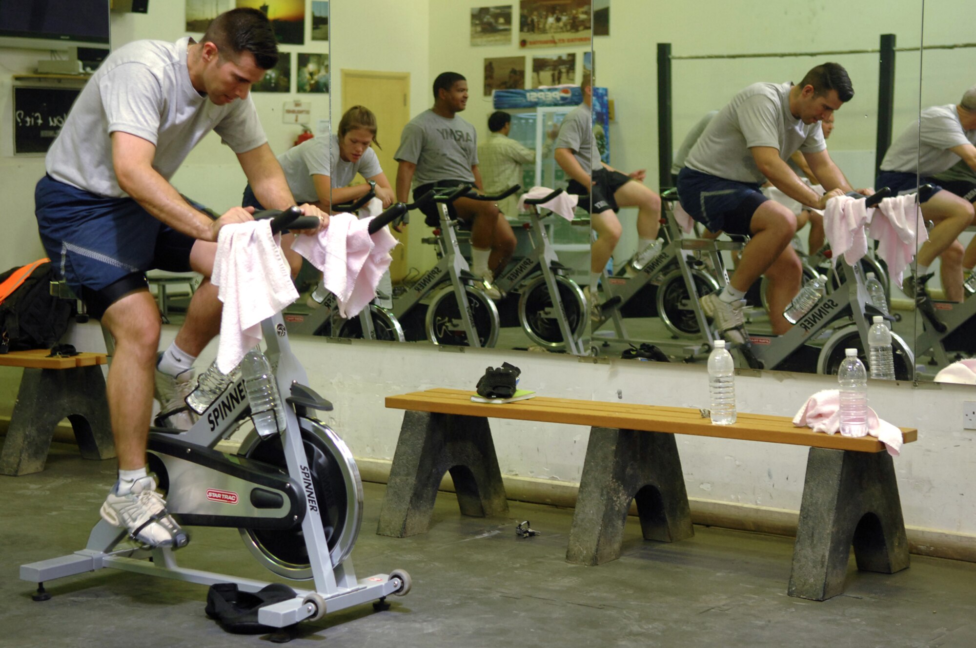BALAD AIR BASE, Iraq -- Tech. Sgt. Emmanuel Ramirez, 332nd Expeditionary Civil Engineer Squadron power production technician, works out on a stationary bike during a class at the Red Tail Fitness Center here, May 31. Maintaining a healthy, physically fit lifestyle helps Airmen to carry out their daily duties more efficiently in a deployed environment. In a typical 40-minute indoor cycling class one could burn between 400 and 600 calories depending upon the level of intensity. Sergeant Ramirez is deployed from Peterson Air Force Base, Colo. (U.S. Air Force photo/ Senior Airman Julianne Showalter)