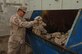 Master Sgt. Johnny Russell, 380th Air Expeditionary Wing Antiterrorism Office and Wing Inspector General Representative, inspects the unservicable uniforms bin.  Sergeant Russell was the 380th AEW Warrior of the Week for the week of May 30, 2008 (U.S. Air Force Photo/Captain Martin Gerst)