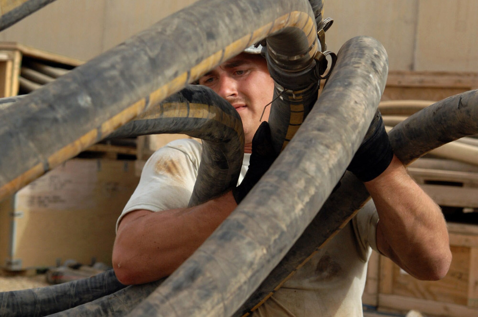 KIRKUK REGIONAL AIR BASE, Iraq -- Tech. Sgt. David Follmuth, 506th Expeditionary Logistics Readiness Squadron, reconfigures a fuel farm bladder pipeline recently here. Sergeant Follmuth is deployed here from Grand Forks Air Force Base, N.D., and is a native of Albert Lee, Minn. (U.S. Air Force photo by Senior Airman SerMae Lampkin)