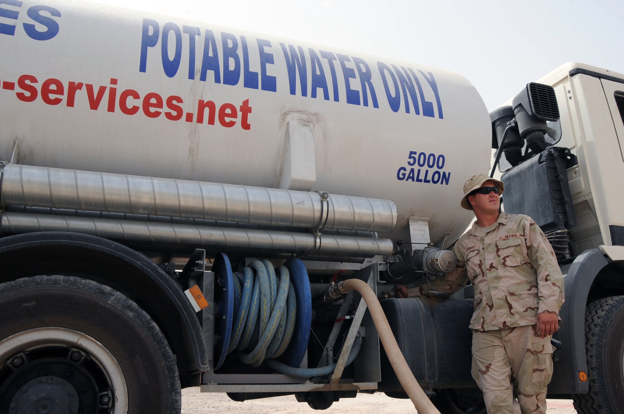 ALI BASE, Iraq -- Airman 1st Class Ricky Schmidt, utilities specialist, refills a water tank May 31. The utilities shop supplies approximately 20,000 gallons of potable water a day to Air Force members and coalition forces here. Airman Schmidt is deployed to the 407th Expeditionary Civil Engineer Squadron from Eielson AFB, Alaska. (U.S. Air Force photo/Tech. Sgt. Sabrina Johnson)