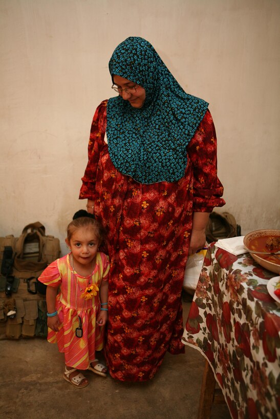 Amenah Al'a Thabit, 3, stands close to her mother, Maha Muhamed Bandar, during a visit with Marines with 3rd Battalion, 4th Marine Regiment, Regimental Combat Team 5, at her home in Haditha, Iraq, June 20 . Amenah traveled to Vanderbilt University in Nashville, Tenn., in January to receive surgery to correct a congenital heart condition. She was the first of three children who have received the surgery. Months after the surgery, she is now running around with her siblings with no problem. ::r::::n::