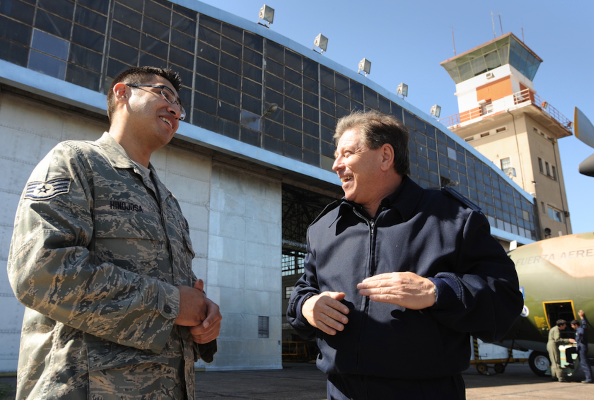 Staff Sgt. David Hinojosa (left) shares stories Oct. 30 with former student (right) Argentinean air force Senior Master Sgt. Jose Minichiello, training superintendent for the 1st Air Brigade, Technical Group D. The exchange between the two countries' Airmen is part of Operation Southern Partner, which brings U.S. Air Force Airmen to South America to have a two-week subject matter exchange emphasizing partnership, cooperation and sharing of information with partner nation Air Forces in Latin America. Sergeant Hinojosa is an aircraft structural maintenance instructor for the Inter-American Air Force Academy at Lackland Air Force Base, Texas. (Air Force photo/Staff Sgt. Bennie J. Davis III) 