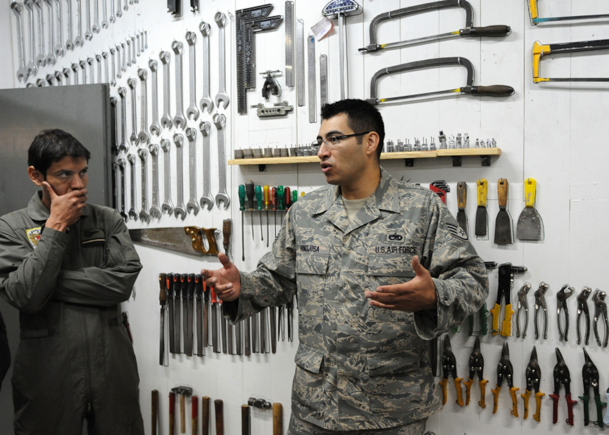 Air Force Staff Sgt. David Hinojosa (right) commends aircraft maintenance mechanics for the proper storage and organization of their units tools during a unit walk-through at Palomar Air Base, Buenos Aires, Argentina on Oct. 30. Sergeant Hinojosa, an aircraft structural maintenance instructor for the Inter-American Air Force Academy at Lackland Air Force Base, Texas. is participating in Operation Southern Partner -- an in-depth, two-week subject matter exchange emphasizing partnership, cooperation and sharing of information with partner nation Air Forces in Latin America. (Air Force photo/Staff Sgt. Bennie J. Davis III) 