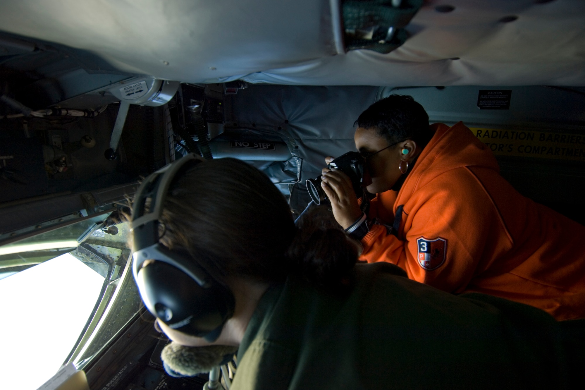 Senior Airman Misty Bice, boom operator for the 171st Air Refueling Squadron, Selfridge ANGB, Mich., refuels a 1st Fighter Wing F-22 Raptor flying out of Langley AFB, Va., while  Dessie Sudberry takes photographs. This KC-135 Stratotanker refueling mission was part of a 127th Wing 'Spouse Lift', where spouses of 127 Air Refueling Group members had a chance to see first hand the group's new mission.
(U.S. Air Force photo by Senior Airman Jeremy L. Brownfield) (Released)