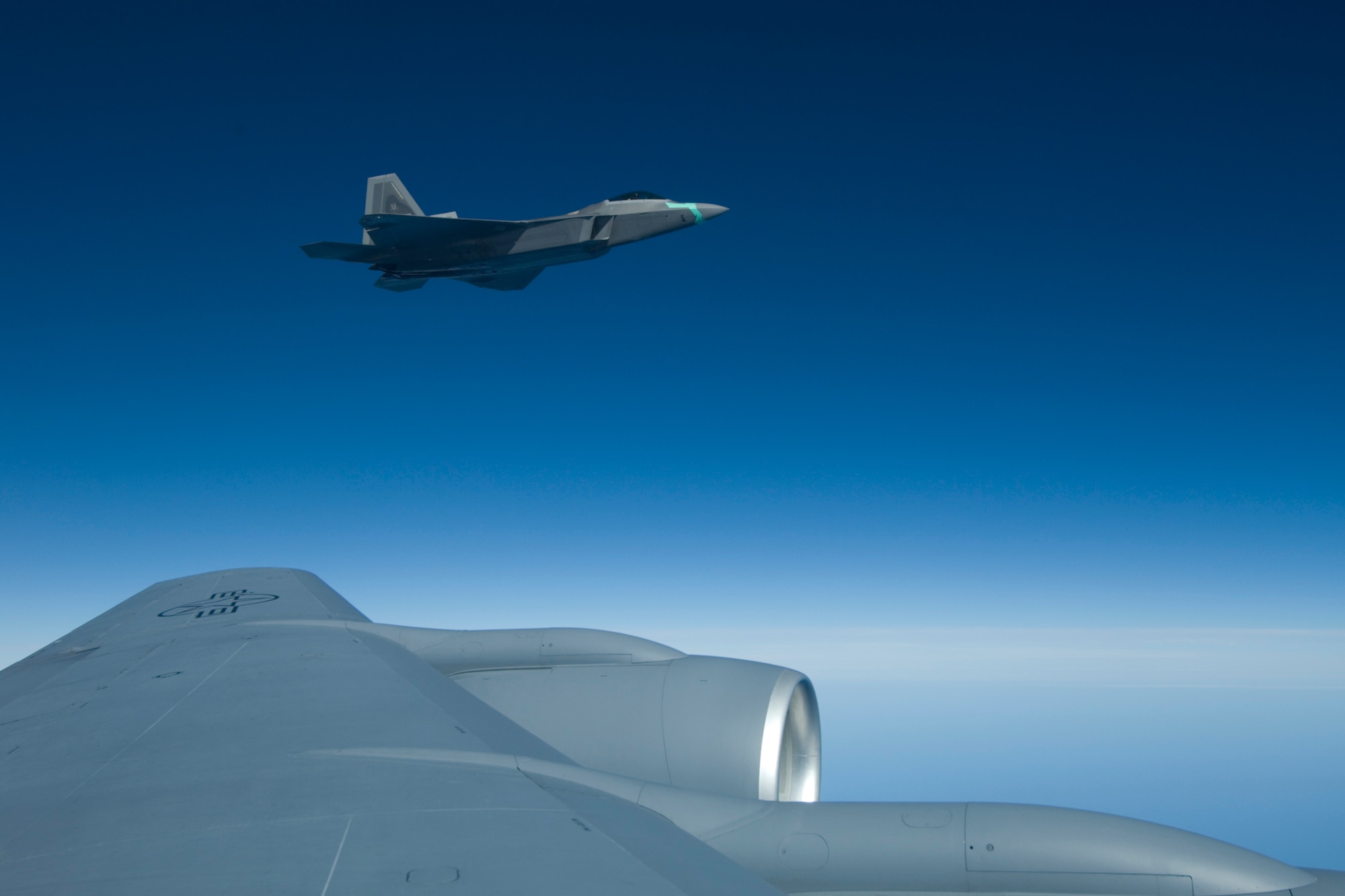 An active duty F-22 Raptor from the 1st Fighter Wing from Langley AFB, Va. takes the wing of a 127th Wing KC-135 Stratotanker from Selfridge ANGB, Mich., during a "Spouse Lift" refueling mission, where spouses of 127 Air Refueling Group members' spouses had a chance to observe the group's new mission first hand on Nov. 1, 2008.  (U.S. Air Force photo by Senior Airman Jeremy L. Brownfield) (Released)