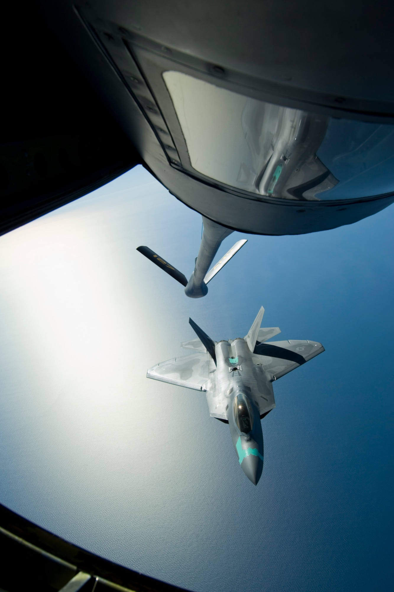 Senior Airman Misty Bice, Boom Operator for the 171st Air Refueling Squadron, Selfridge ANGB, Mich., refuels a 1st Fighter Wing F-22 Raptor flying out of Langley AFB, Va. This historic occasion marked the first time for many 127th Wing airmen to see the newest fighter in the Air Force fleet. (U.S. Air Force Photo by Senior Airman Jeremy L. Brownfield) (Released)