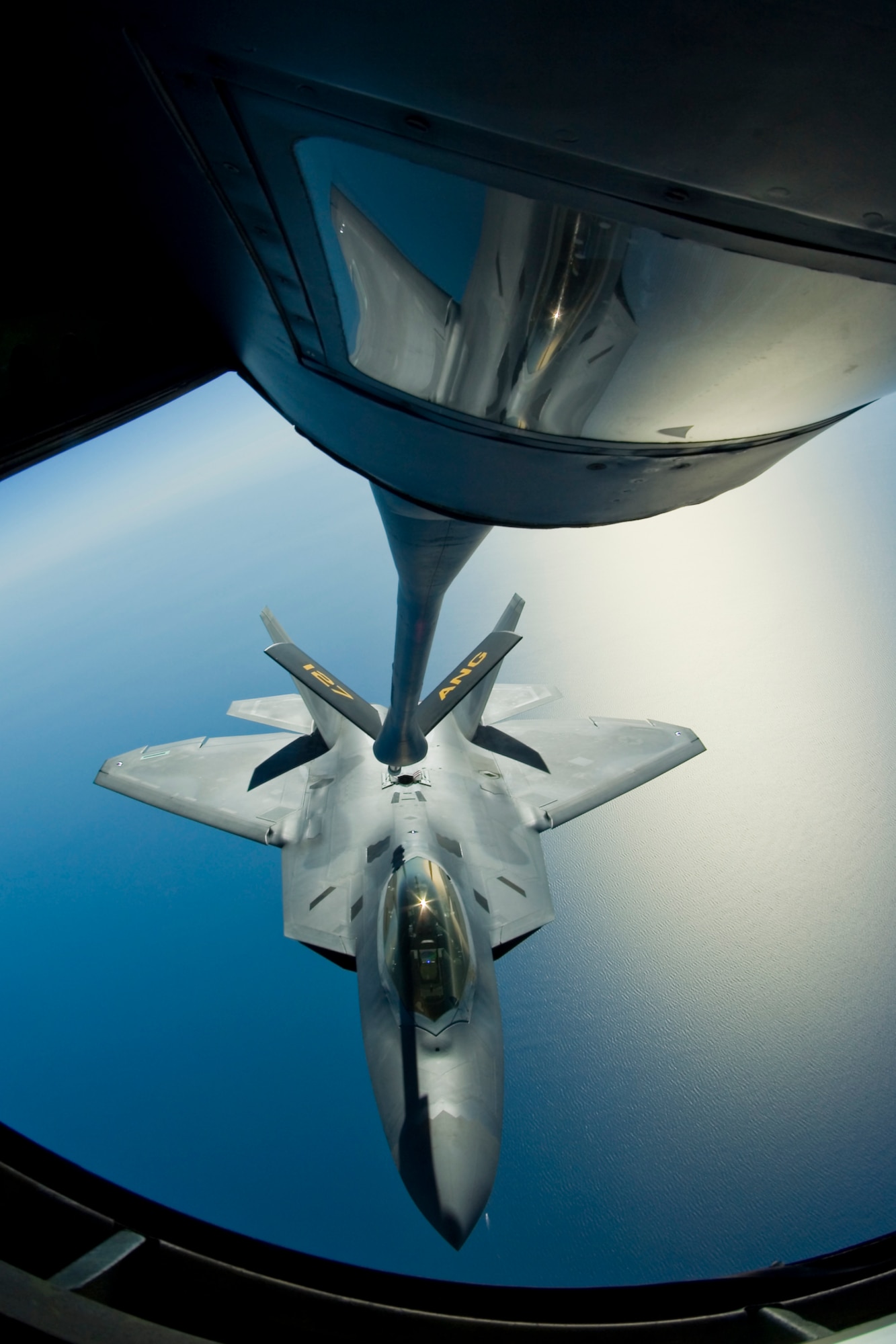 Senior Airman Misty Bice, boom operator for the 171st Air Refueling Squadron, Selfridge ANGB, Mich., refuels a 1st Fighter Wing F-22 Raptor flying out of Langley AFB, Va. This historic occasion marked the first time for many 127th Wing airmen to see the newest fighter jet in the Air Force fleet. (U.S. Air Force Photo by Senior Airman Jeremy L. Brownfield) (Released)