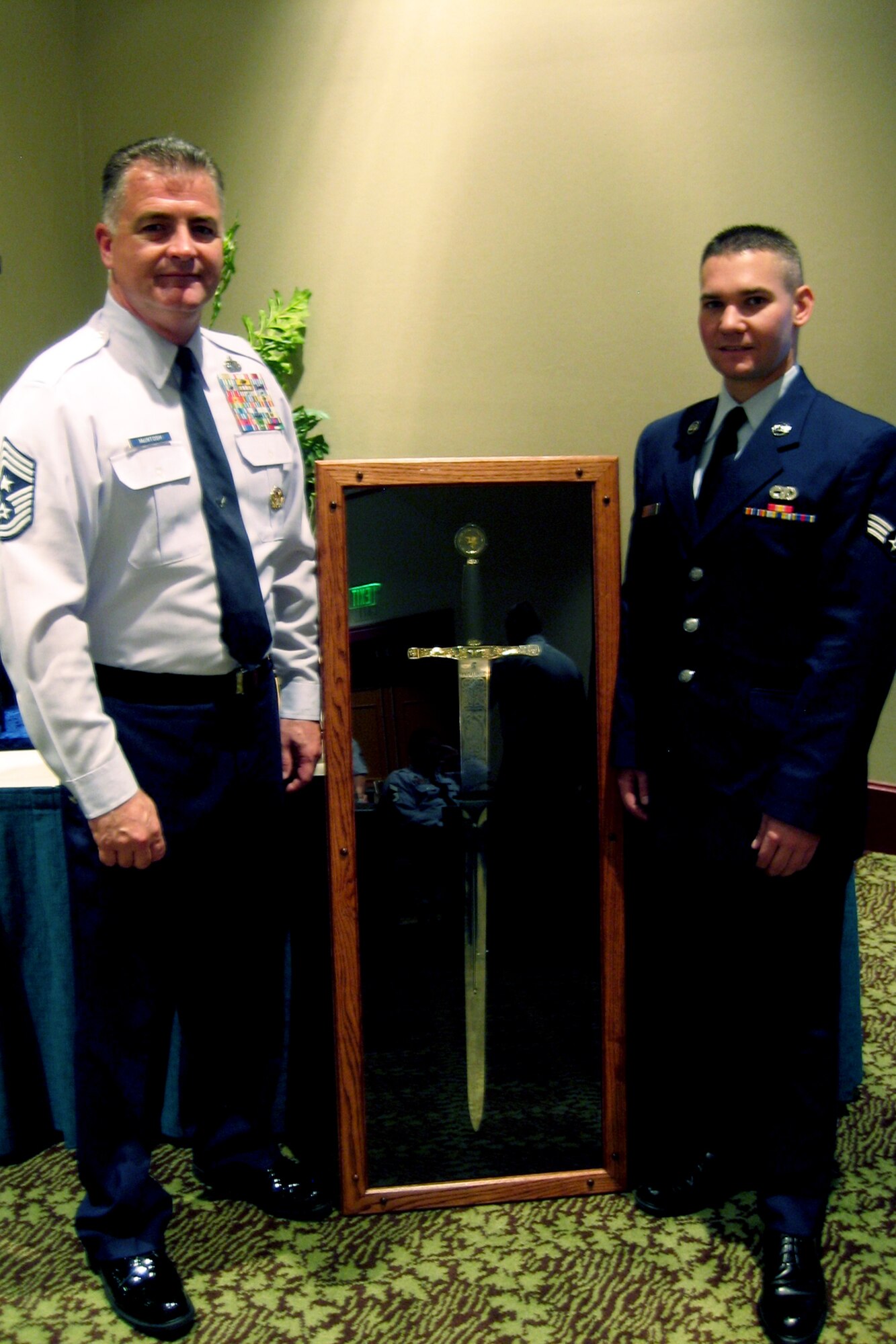 ROBINS AIR FORCE BASE, Ga., -- Chief Master Sgt. Troy McIntosh, command chief for Air Force Reserve Command, stands with Senior Airman Bart Erwin, 49th Aerial Port Flight, during an enlisted symposium held at Robins recently. (U.S. Air Force photo)