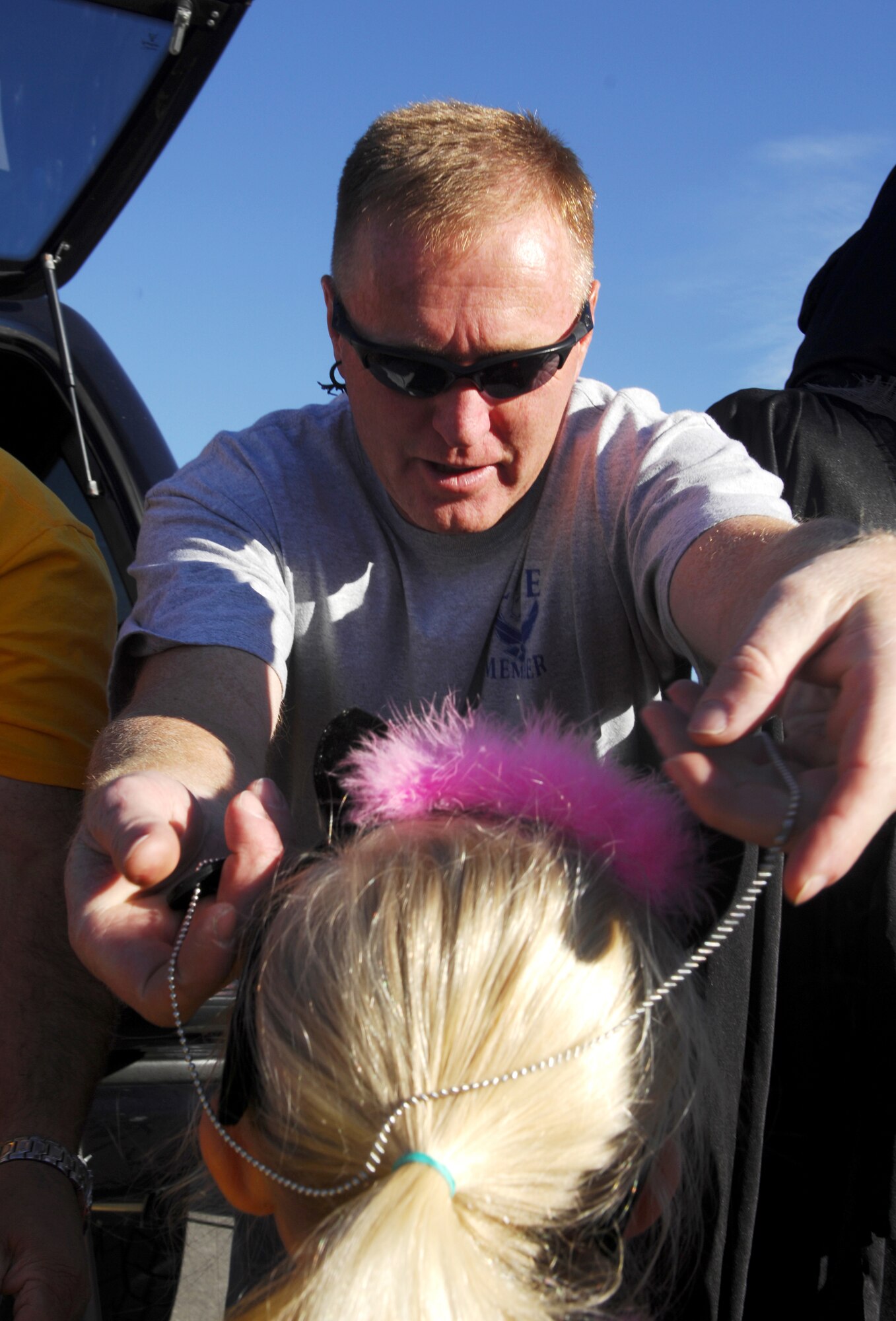 Chief Master Sgt. Robert Hill, Command Chief for the Utah Air National Guard, places a dog tag around the neck of a "trunk-or-treater" at the Utah National Guard's fifth annual Trunk-or-treat event.  The event was hosted by the Utah National Guard's Family Programs Office and showcased several booths that UTNG children could trick-or-treat.  The festivities also included clowns, bounce houses, and free hotdogs and soda.  
U.S. Air Force photo by Master Sgt. Burke Baker  