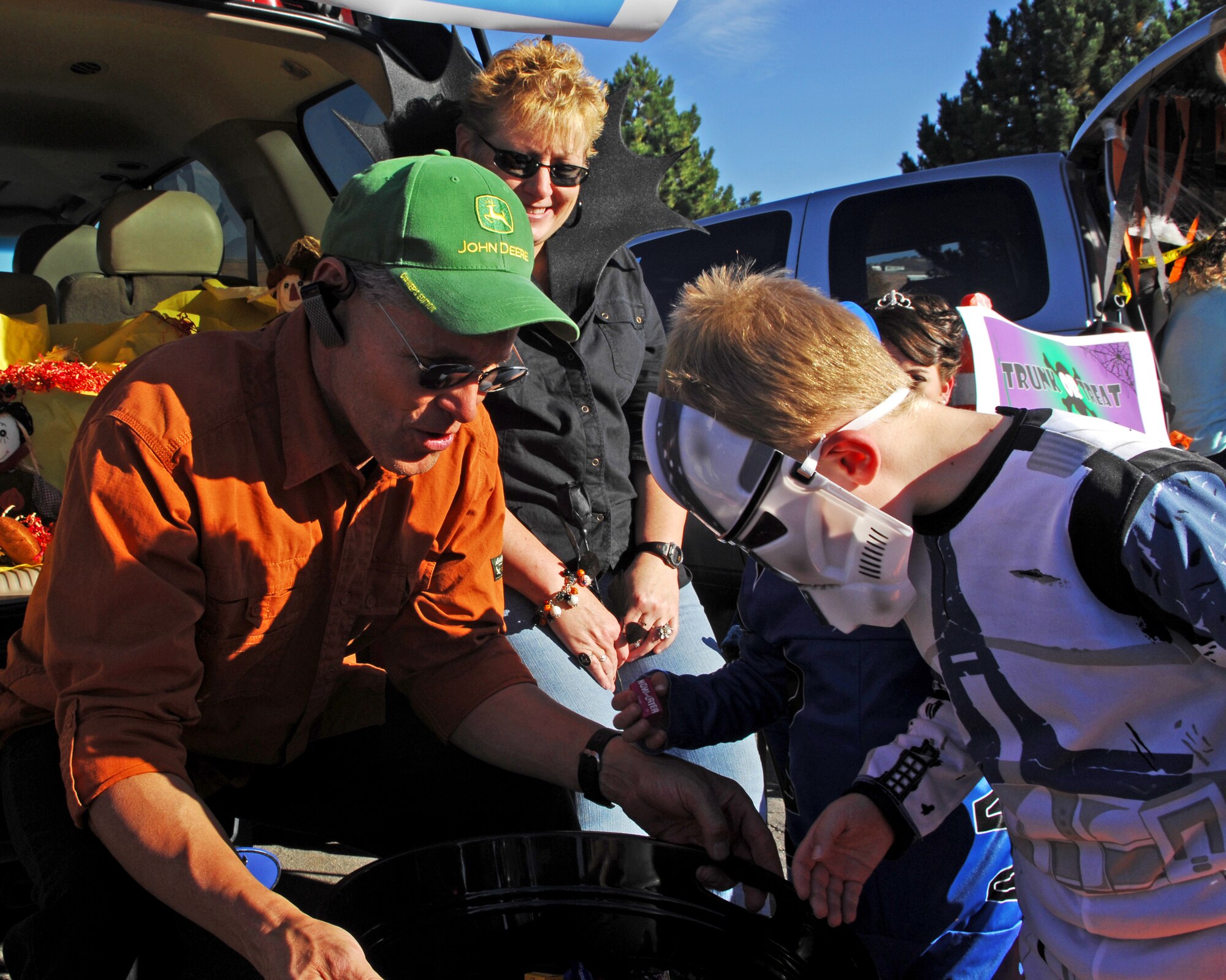 Garrett Baker picks out of piece of candy as Senior Master Sgts. Steven Schiele and Cheryl Larsen watch.  The sergeants were representing the Utah Air National Guard's Top-3 organization at the Utah National Guard's fifth annual Trunk-or-treat.  The event was hosted by the Utah National Guard's Family Programs Office and showcased several booths that UTNG children could trick-or-treat.  The festivities also included clowns, bounce houses, and free hotdogs and soda.  
U.S. Air Force photo by Master Sgt. Burke Baker  