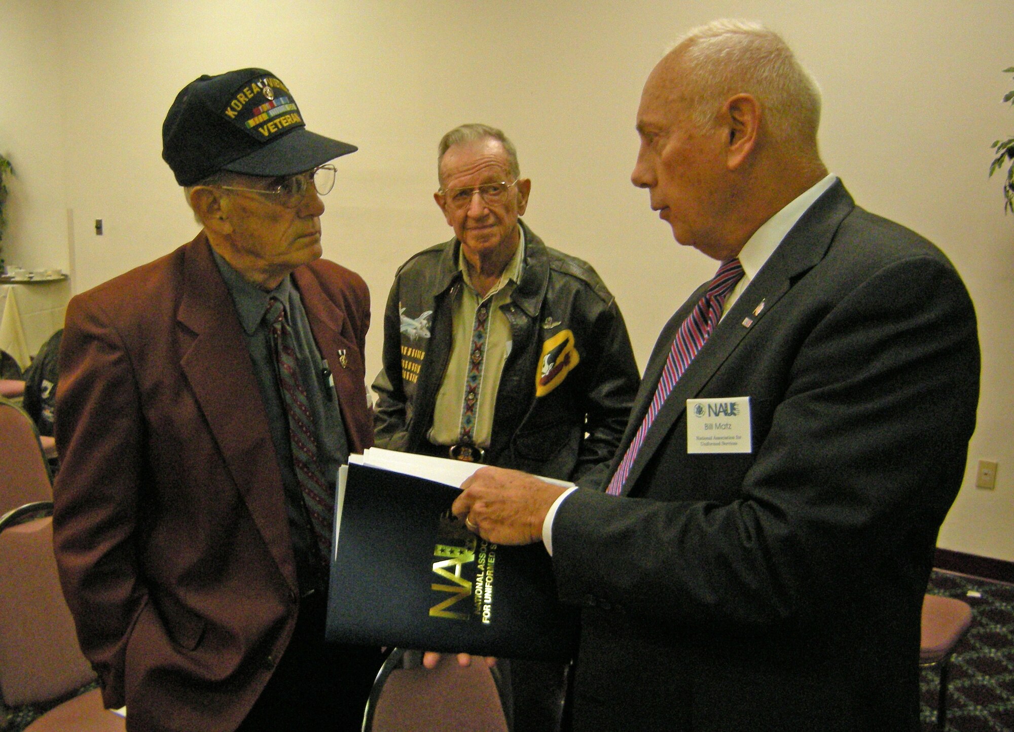 Retired Marine Sgt. Maj. James Snyder and Air Force Col. Les Dunning, both of Kettering, Ohio, discuss military retiree benefits with retired Army Maj. Gen. Bill Matz, president of the National Association of the Uniformed Services.  Matz was a featured speaker for Retiree Appreciation Day Oct. 29 at Wright-Patterson Air Force Base.  (U.S. Air Force photo/Derek Kaufman)