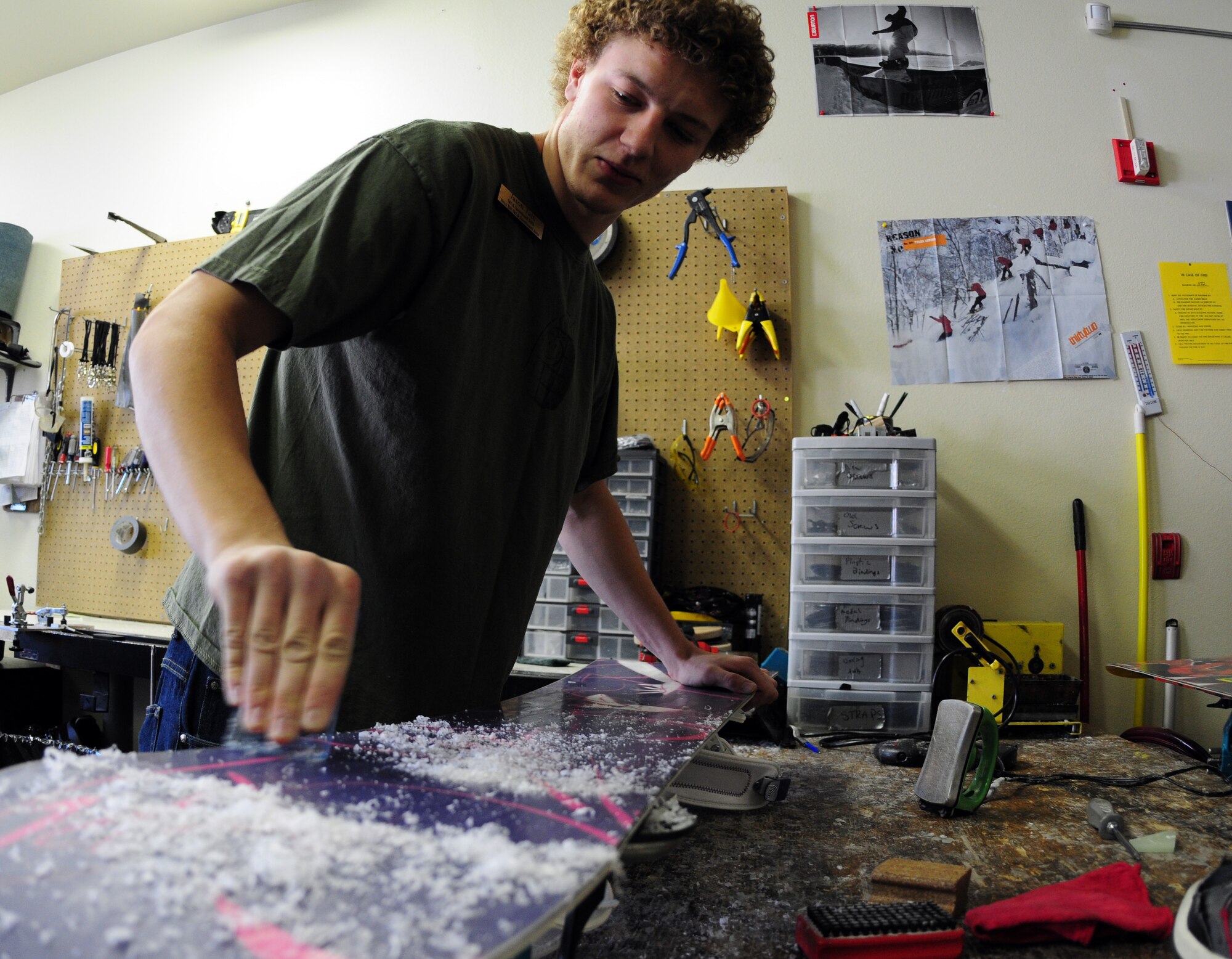 Mr. Jason Tate waxes a snowboard Nov.1, 2008, at Birch Hill Ski Resort on Fort Wainwright, Alaska. For a small fee, resort staff member Mr. Tate can wax skis and snowboards in a few minutes to maximize performance. (U.S. Air Force photo/Airman Laura Max)