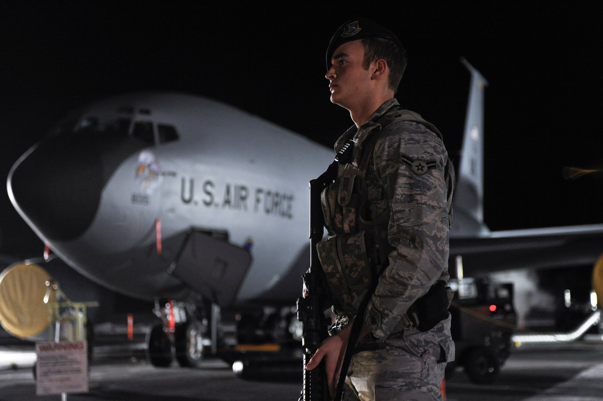 Airman 1st Class Tony Gross stands guard in front of a KC-135R Stratotanker during a 354th Fighter Wing and 168th Air Refueling Wing combined Operational Readiness Exercise Nov. 1, 2008, at Eielson Air Force Base, Alaska. The 354th FW ensures success of the 168th ARW mission, which is to train and equip KC-135R combat crews to provide air refueling in support of operations in the Pacific region. Airman Gross is assigned to the 354th Security Forces Squadron.  (U.S. Air Force photo/Senior Airman Jonathan Snyder)