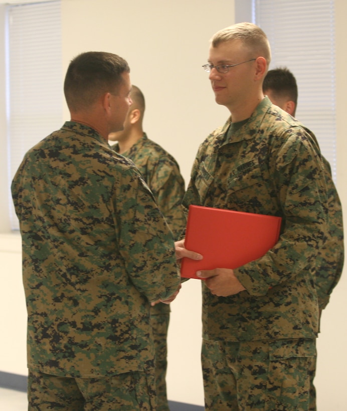 Sergeant Justin Burkett, a chemical, biological, radiological, and nuclear defense specialist with Headquarters Battalion, 2nd Marine Division, receives his promotion warrant after winning a meritorious sergeant board Oct. 24.  “I’ll tell ya what, when they announced my name it took me about two seconds to realize they pronounced it wrong,” he said.